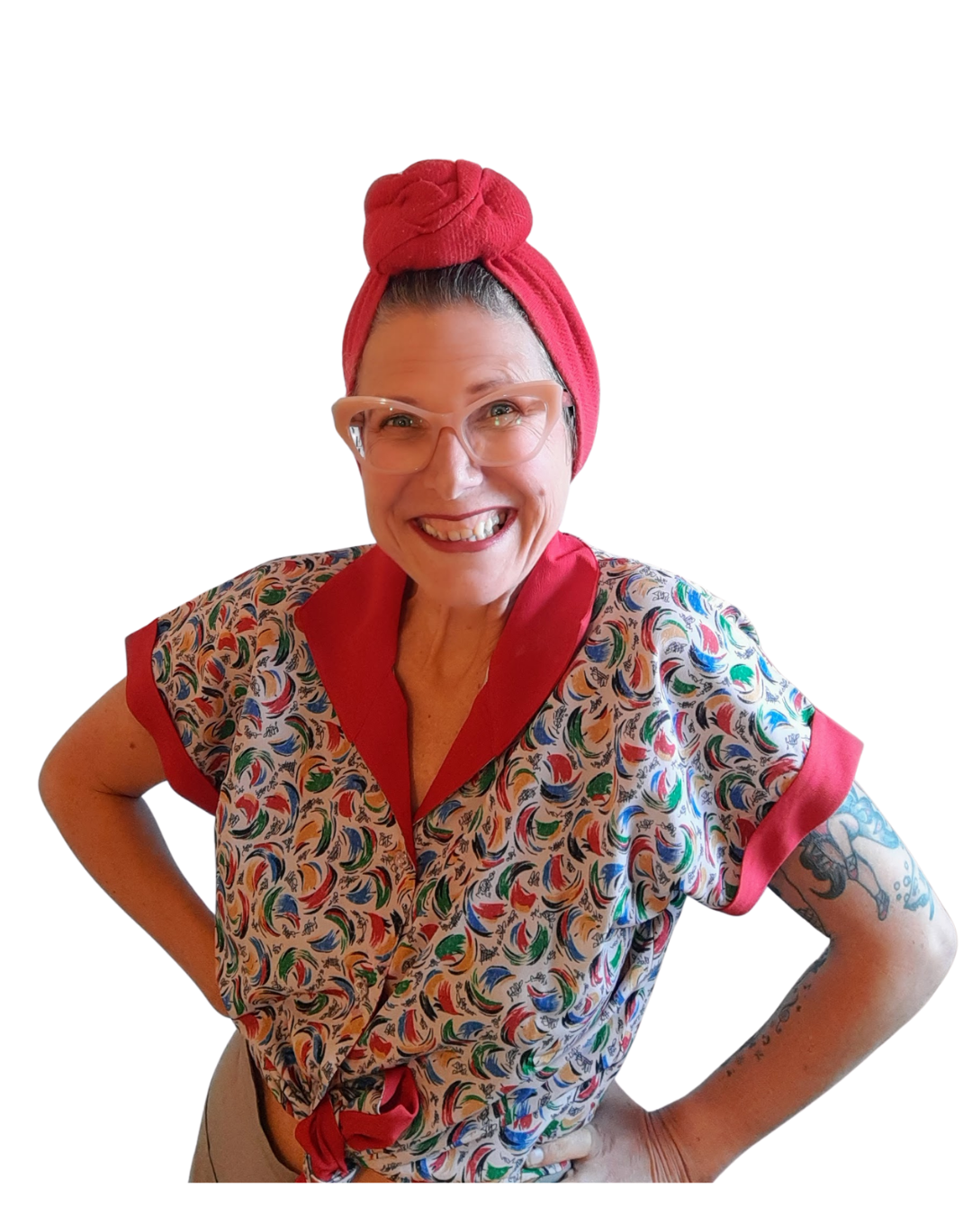 Ali Stripling is smiling confidently at her audience before she delivers a workplace session on menopause.  She is vibrant and full of energy.  She looks informal and unique because she is wearing her on brand vintage 1950s style.