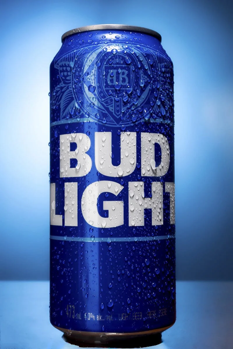 Bud Light blue aluminum can with water droplets, studio lighting