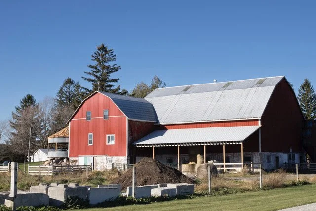 Red barn on a farm with blue sky
