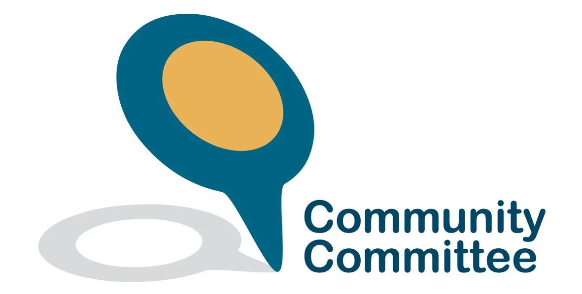Logo featuring a map pin with a yellow circle inside, accompanied by the text "Community Committee."