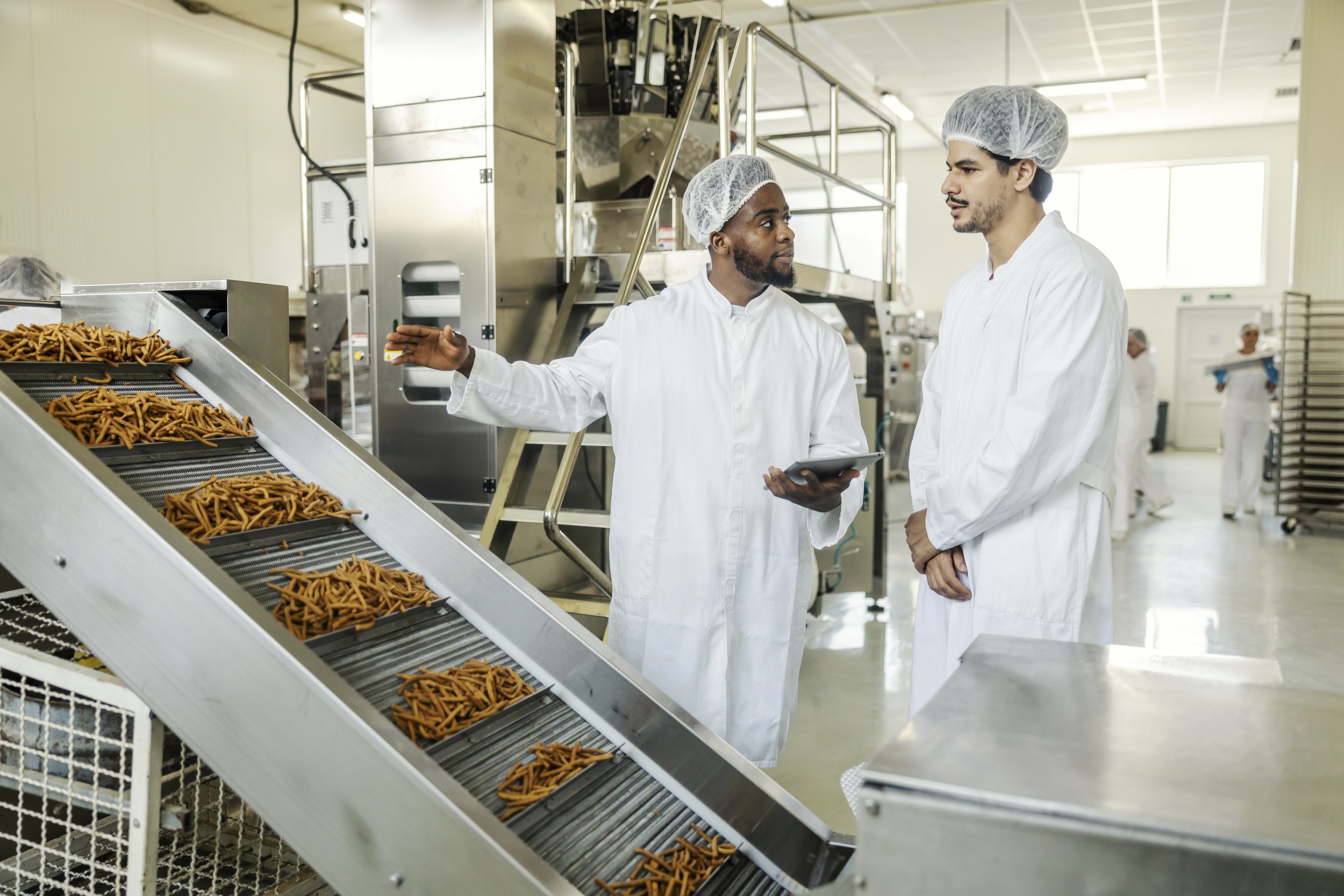 multicultural-supervisor-holding-tablet-checking-production-line-while-talking-operator.jpg
