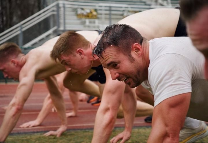 Athletes in starting position preparing to race on a track.