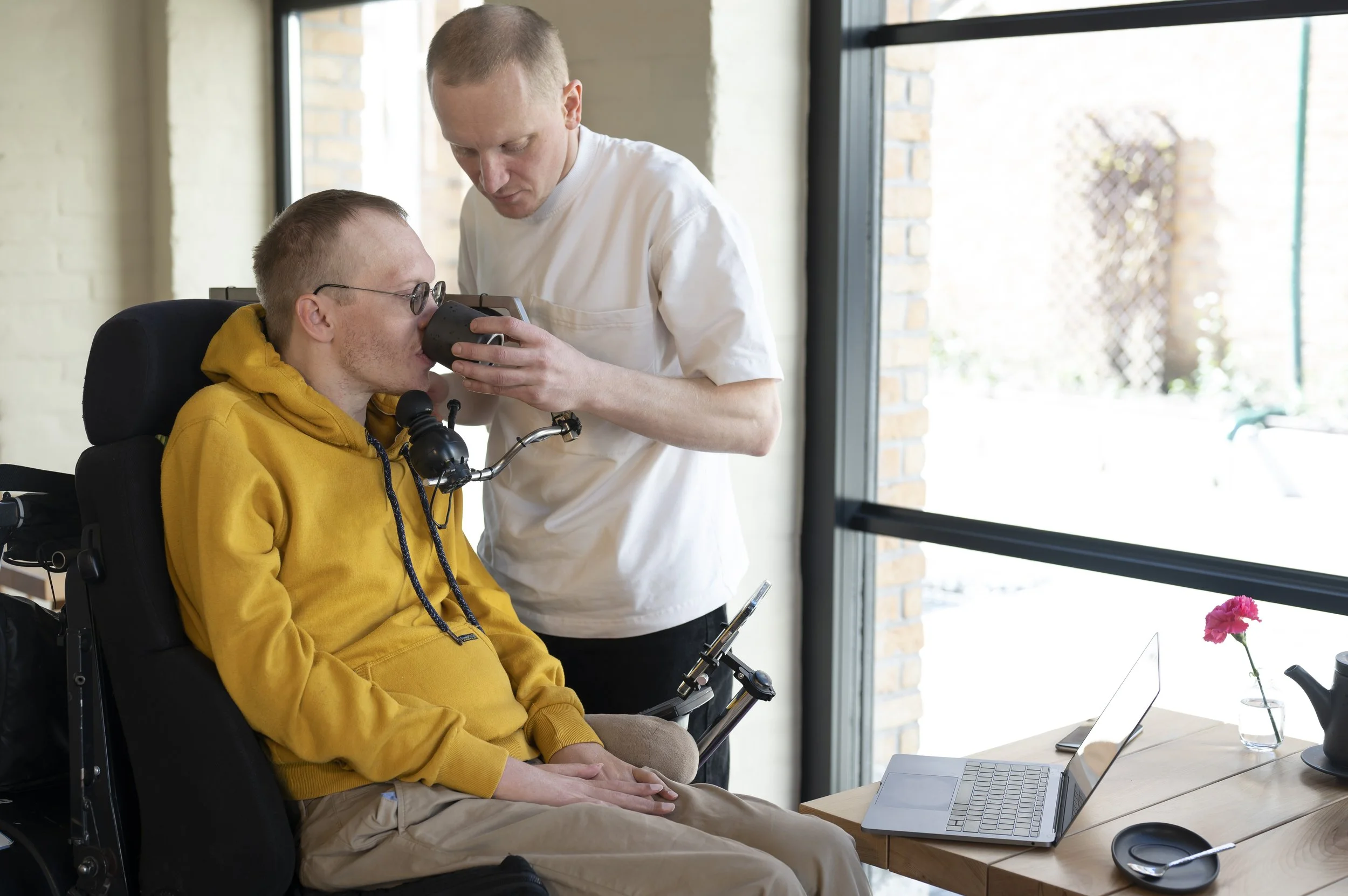 support worker helping a client on wheelchair