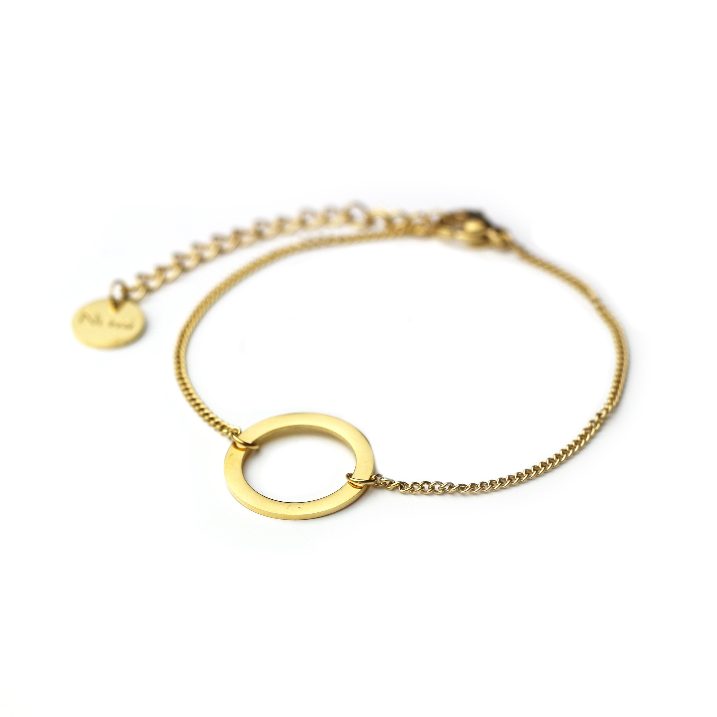 Gold bracelet with a circular ring centerpiece and a chain with a small engraved charm.