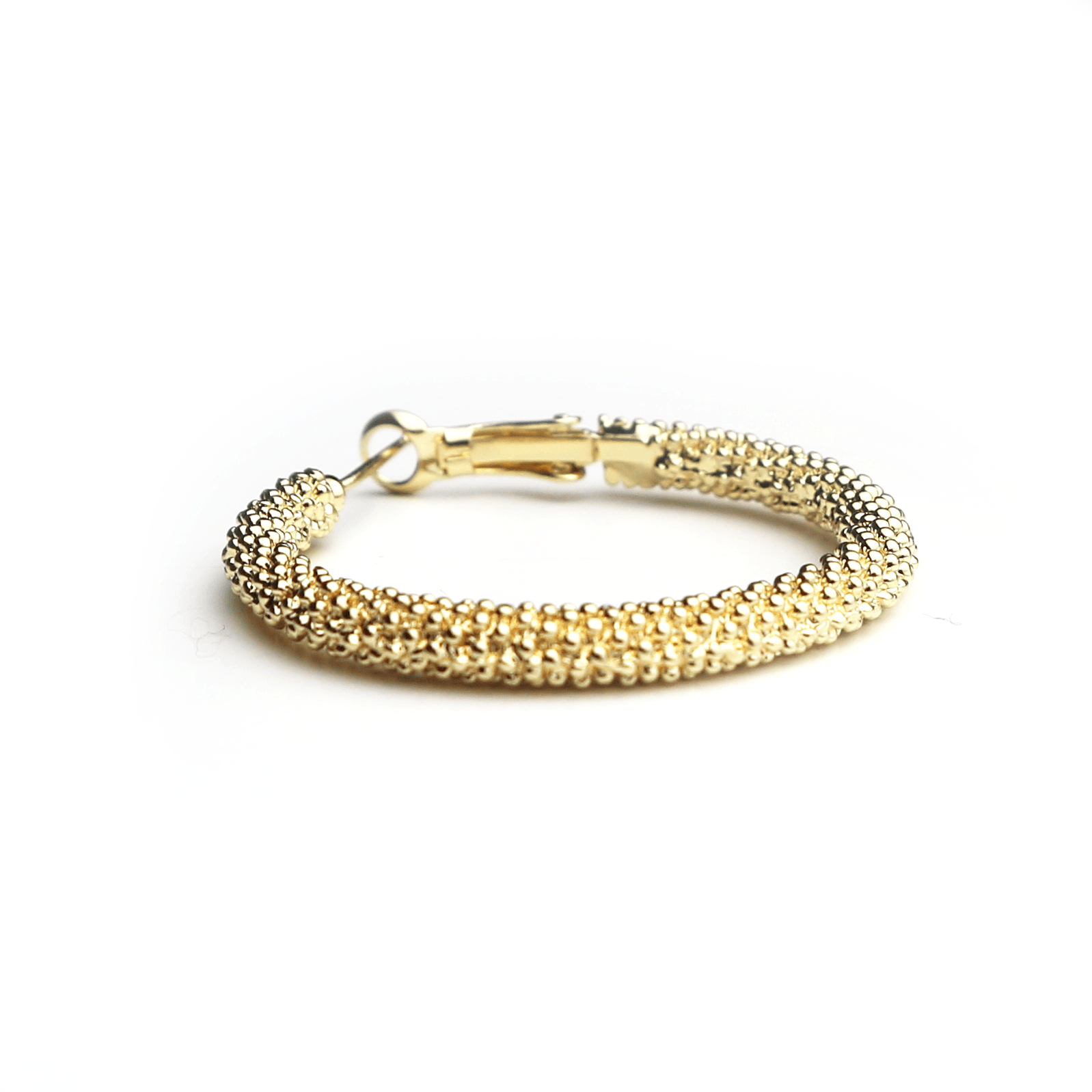 Gold textured bracelet with clasp on white background.