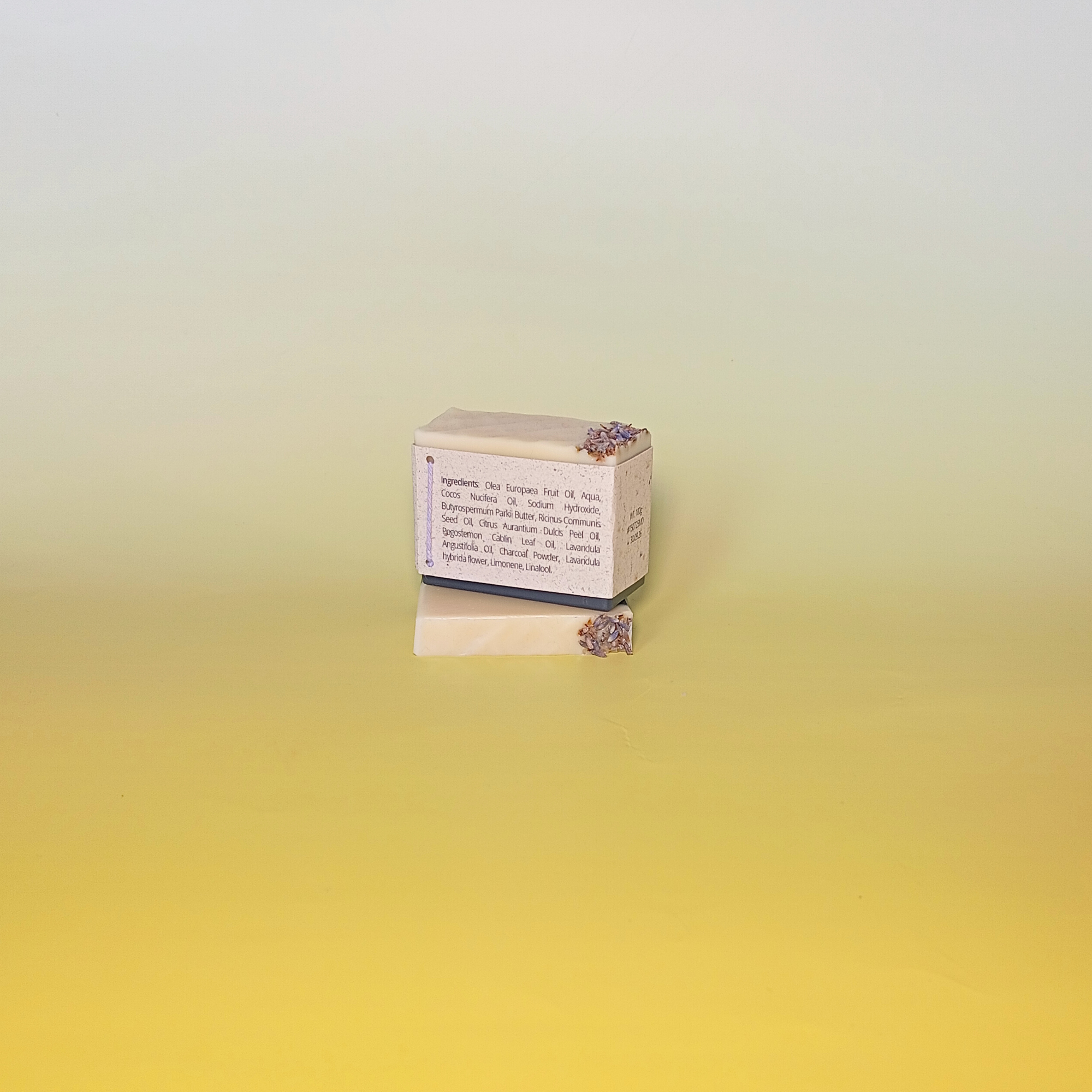 Handmade soap bar wrapped in a beige recycled paper sleeve with printed product name and details, showcasing eco-friendly and natural packaging design