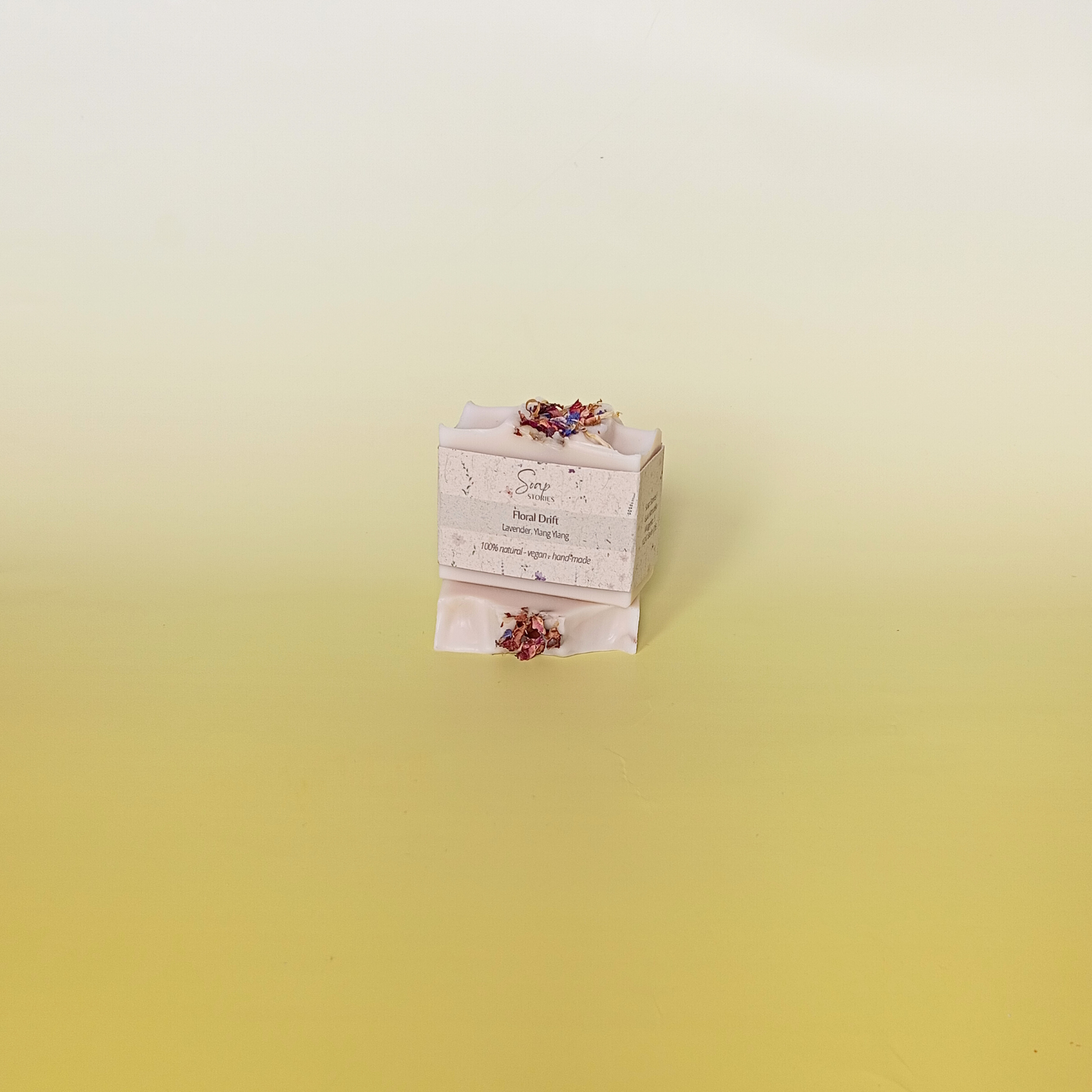 Handmade soap bar wrapped in a beige recycled paper sleeve with printed product name and details, showcasing eco-friendly and natural packaging design