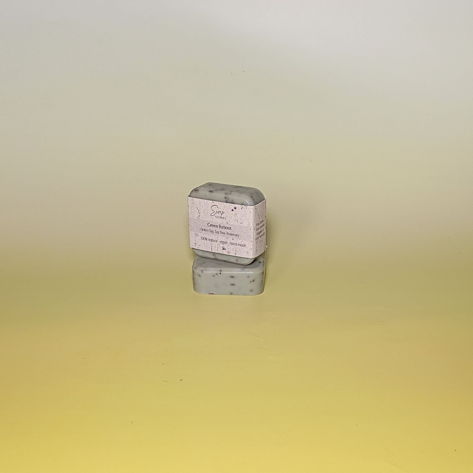 Green soap bar wrapped in natural grass paper sleeve