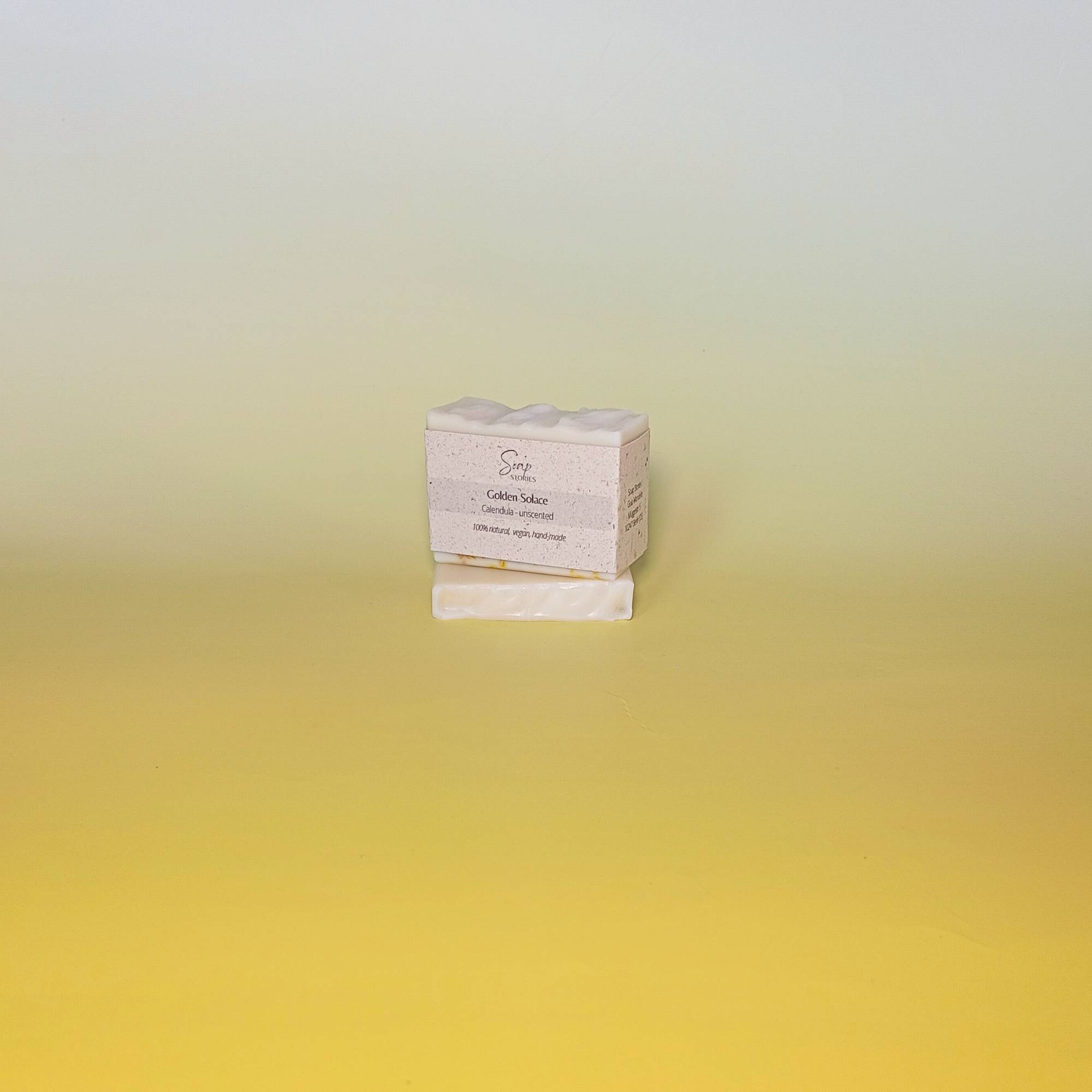 Handmade calendula soap bar wrapped in a beige recycled paper sleeve with printed product name and details, showcasing eco-friendly and natural packaging design
