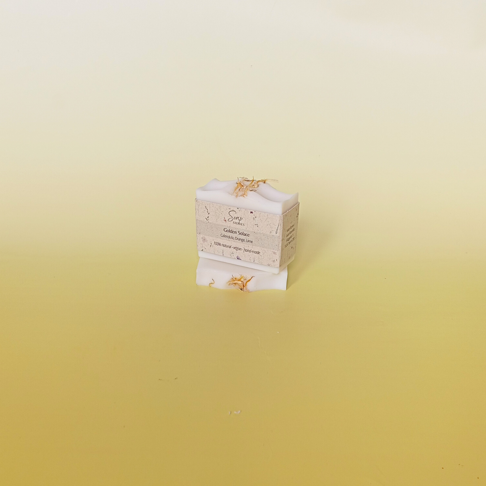 Handmade soap bar wrapped in a beige recycled paper sleeve with printed product name and details, showcasing eco-friendly and natural packaging design