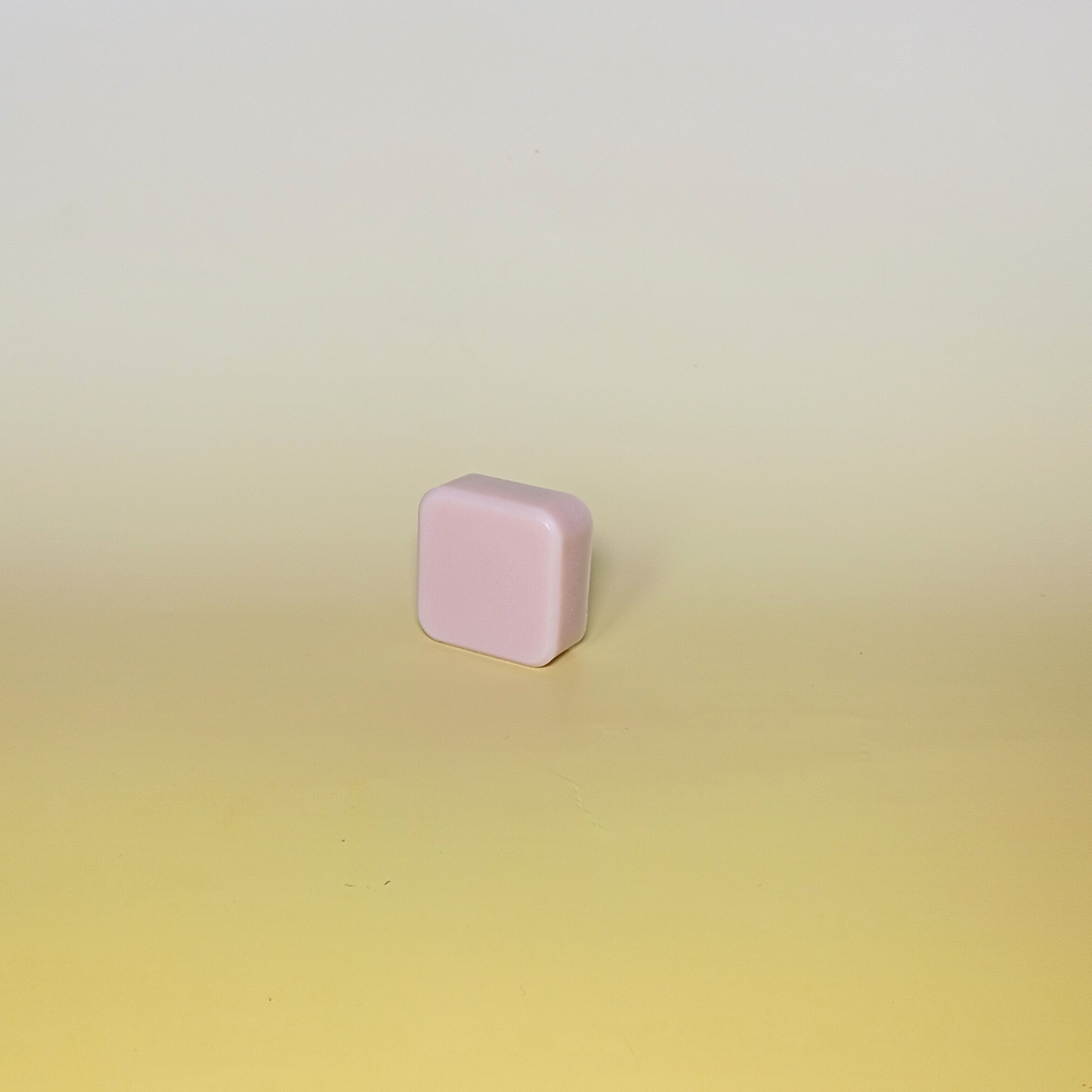 Handmade soap bar in soft lavender tone with nourishing oils, scented with lavender and rosemary essential oils. Shown on a pale yellow background.