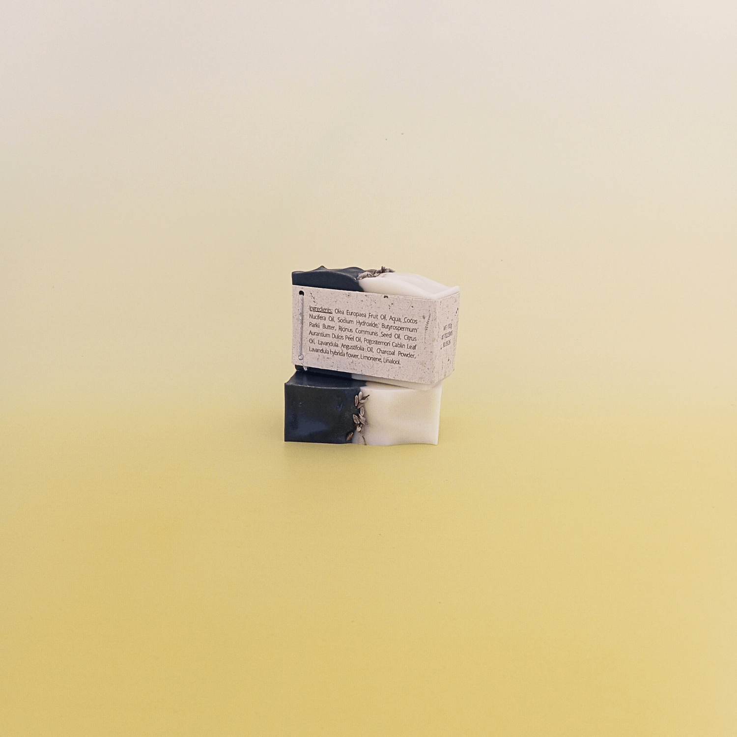 Handmade soap bar wrapped in a beige recycled paper sleeve with printed product name and details, showcasing eco-friendly and natural packaging design