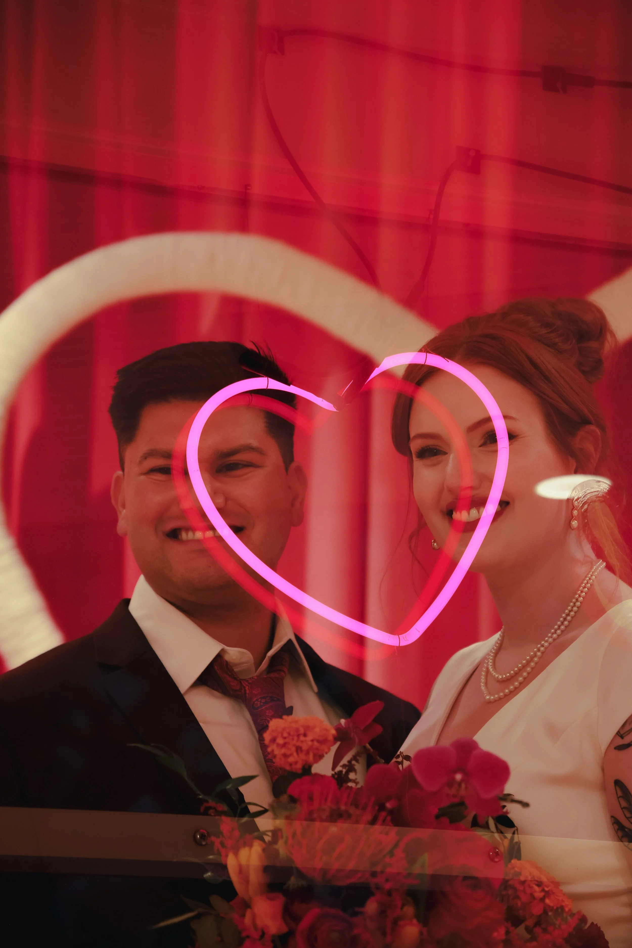 Heart neon light with a couple at the altar of lucky in love chapel 