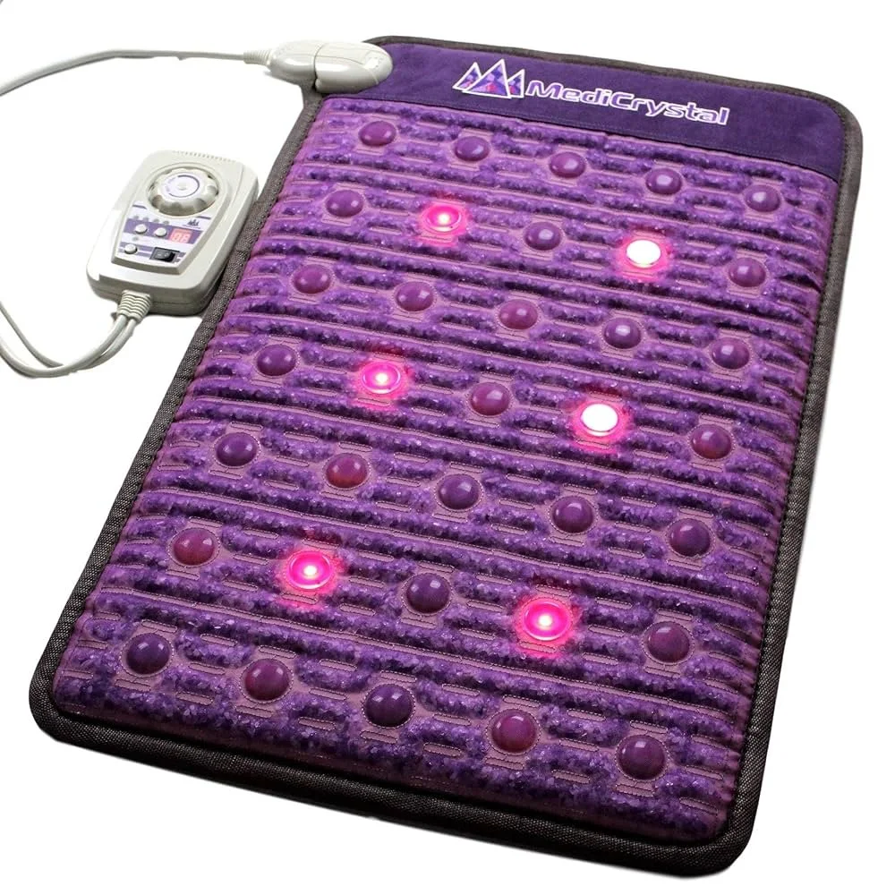 A purple heated massage mat with multicolored ridges and round nodes, connected to a control device with wires, displaying red and white lights.