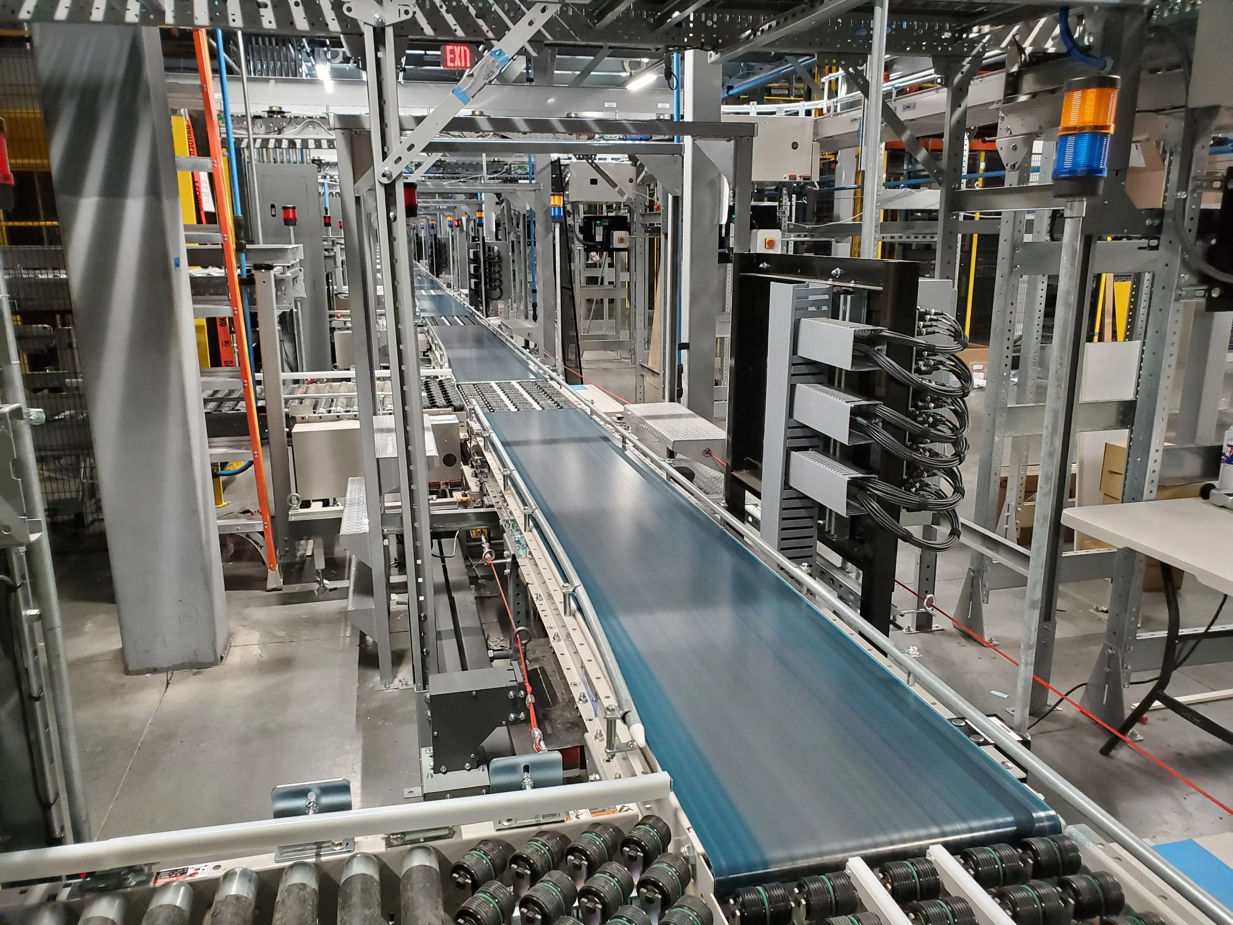 Industrial conveyor system with machinery in a factory setting.