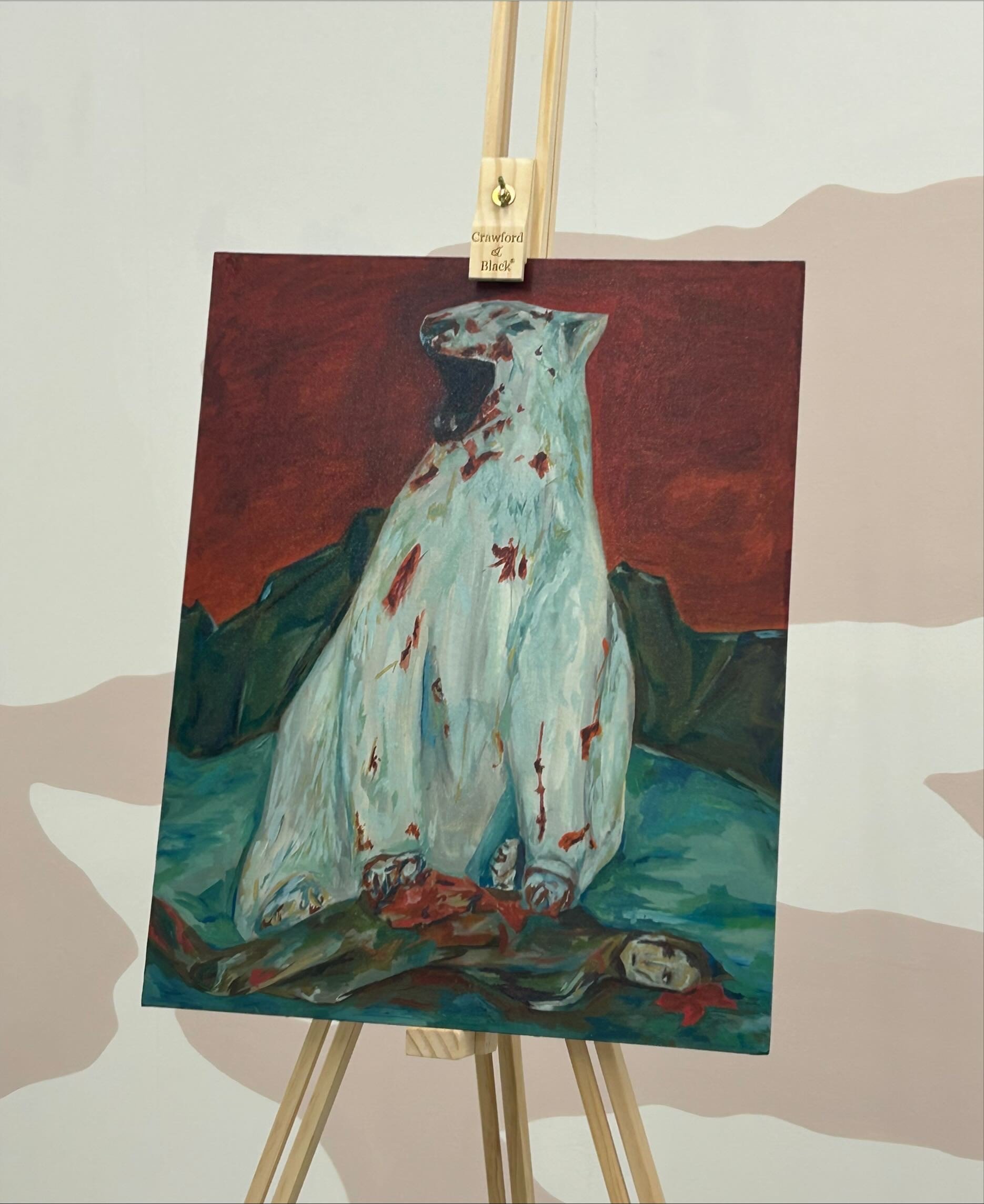 A painting on an easel depicting a polar bear with red marks against a dark background.