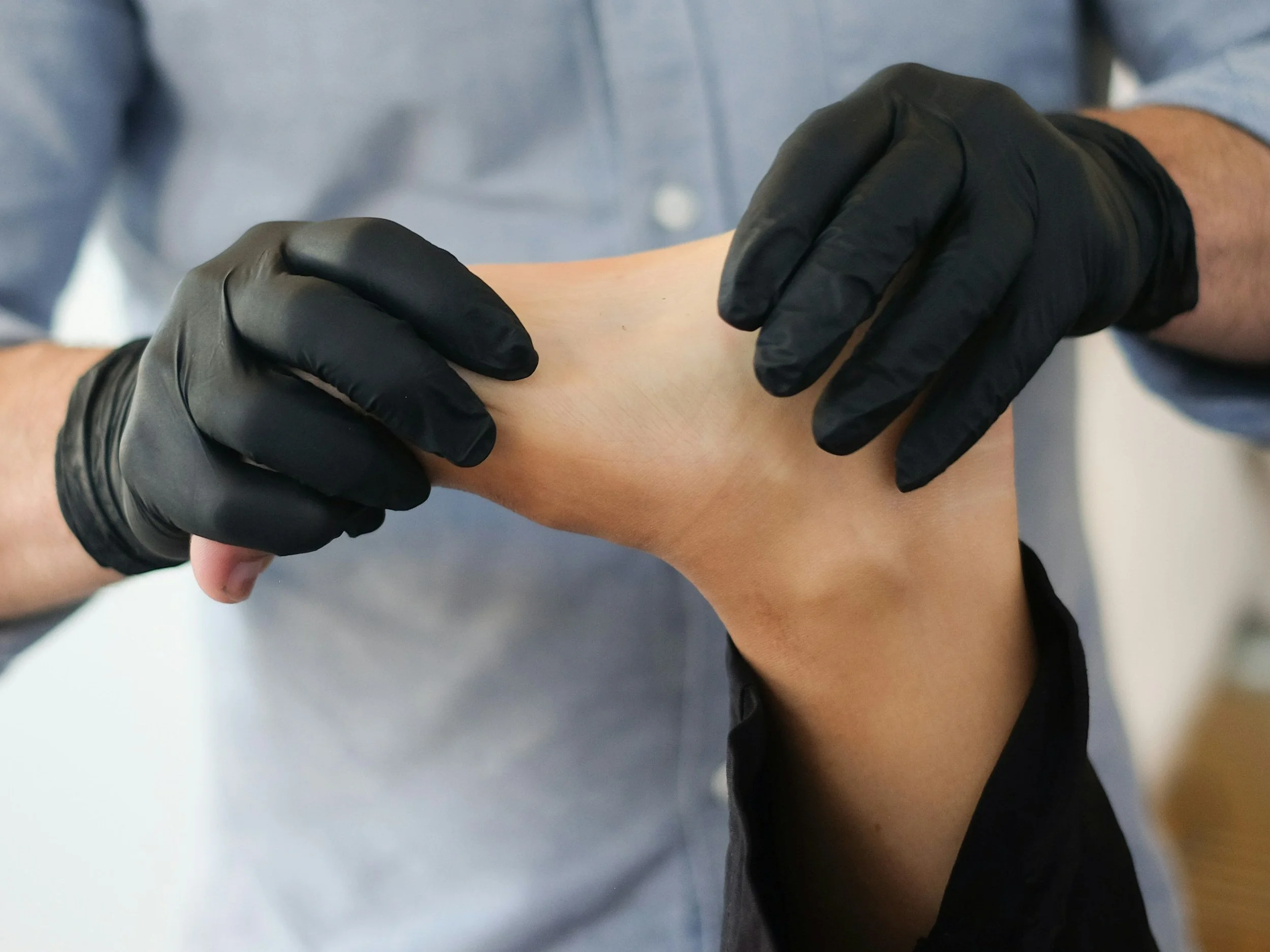 Health expert treating athletic patient's foot