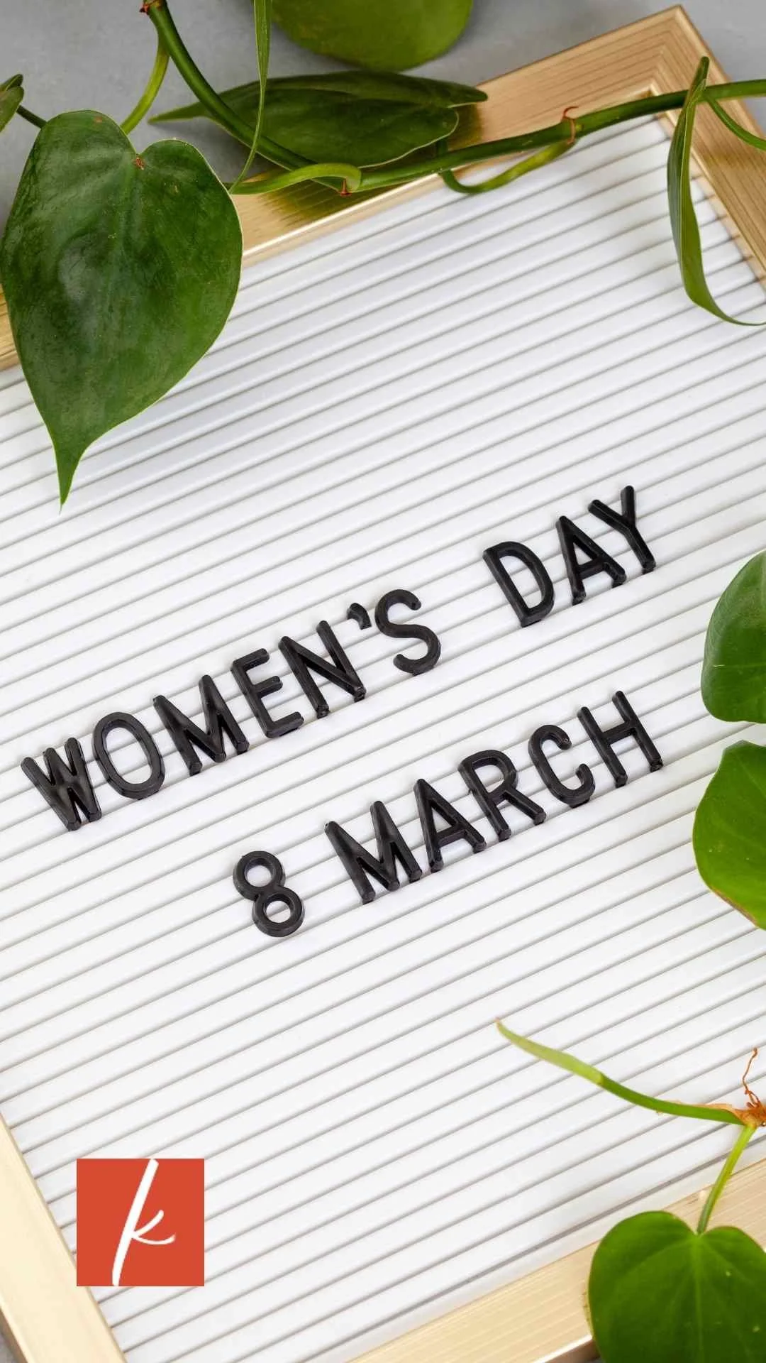 Letter board displaying the text “Women’s Day 8 March” surrounded by green plants.