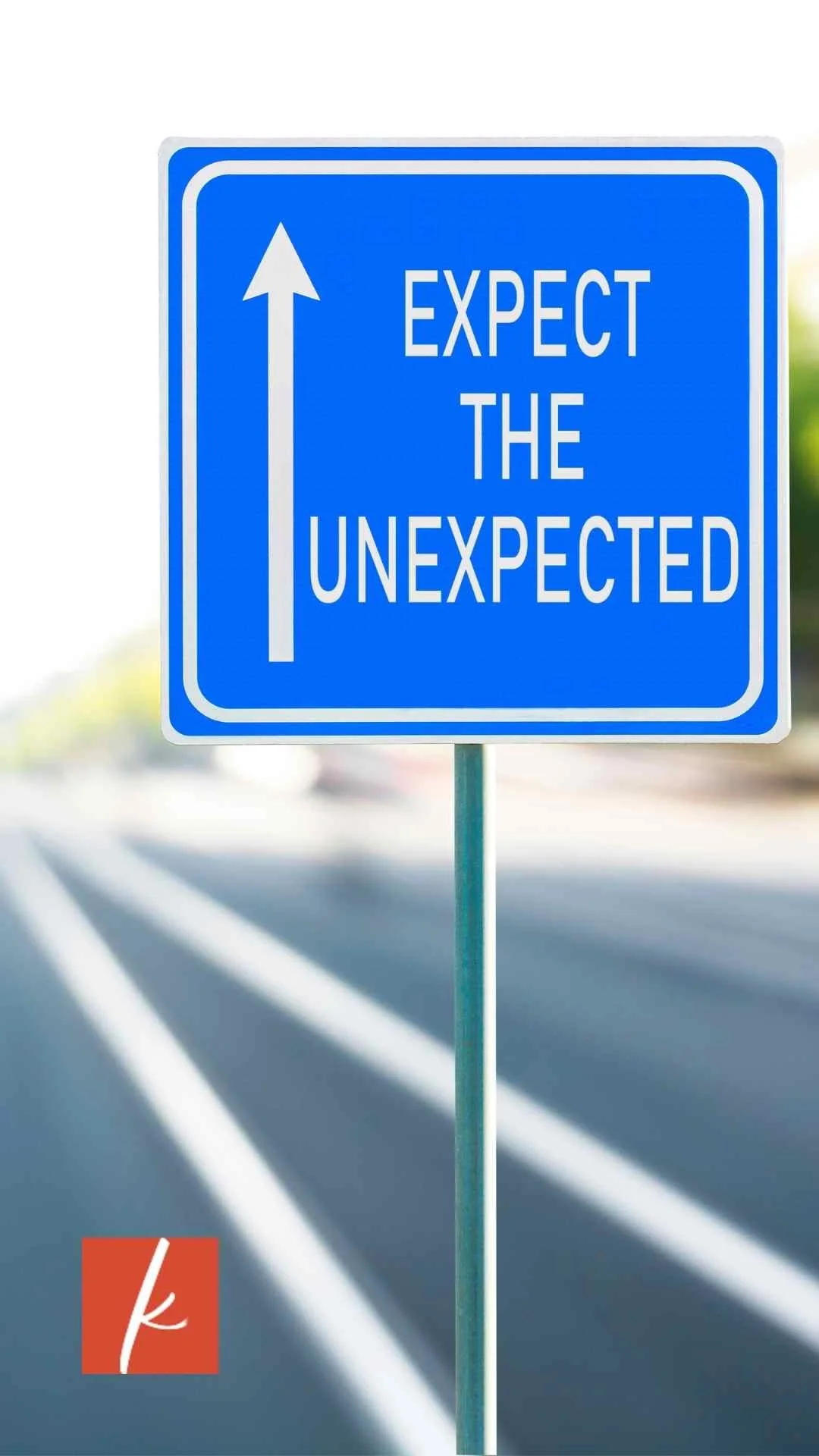Blue road sign that reads ‘Expect the Unexpected’ with an upward arrow.