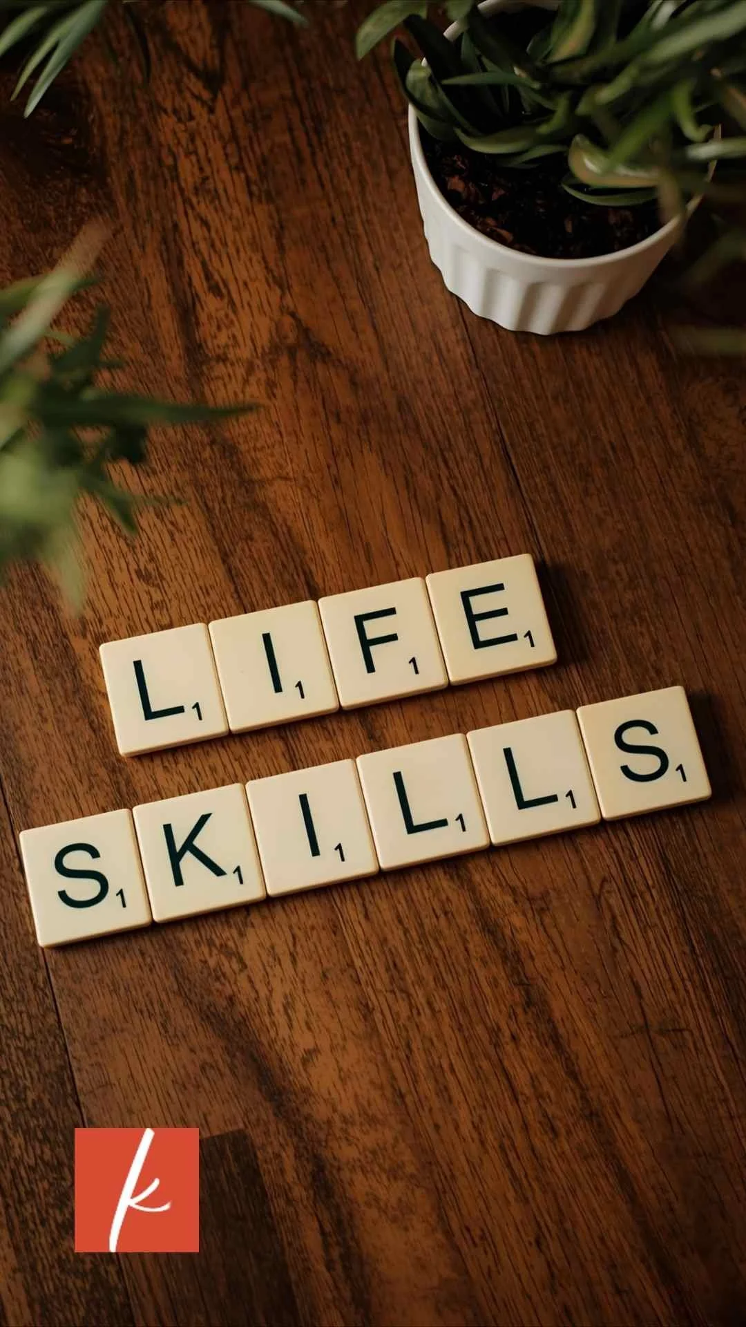 Close-up of letter tiles arranged to spell ‘Life Skills’ on a wooden tabletop.