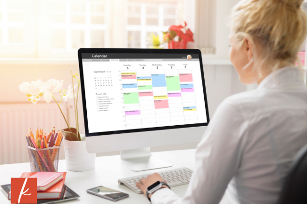 Women looking at her scheduled on a desktop computer