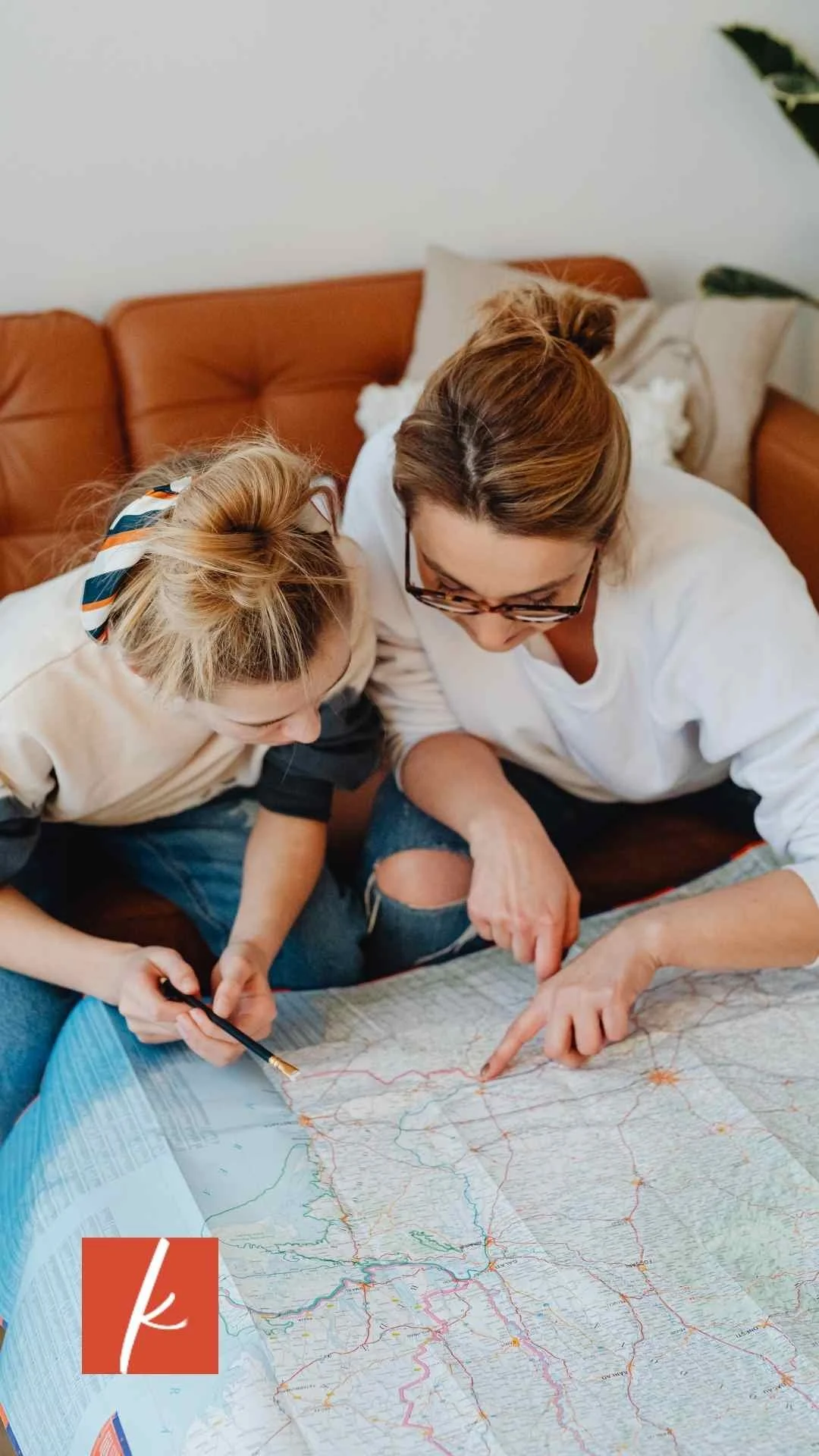 Two women collaborating over a map, symbolizing planning and direction.