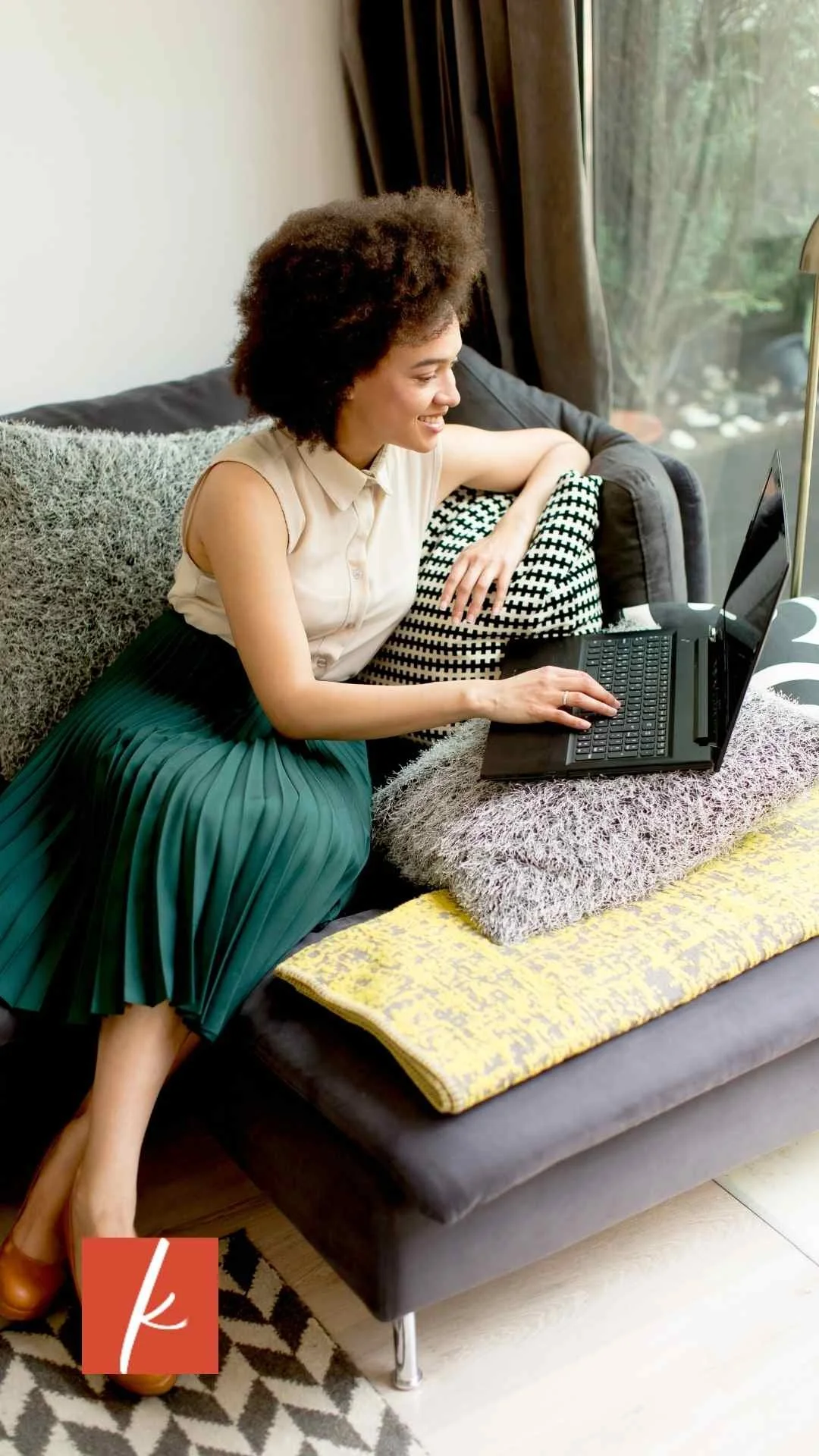Woman sitting at laptop reflecting on small business goals to rest before Q2 ends.