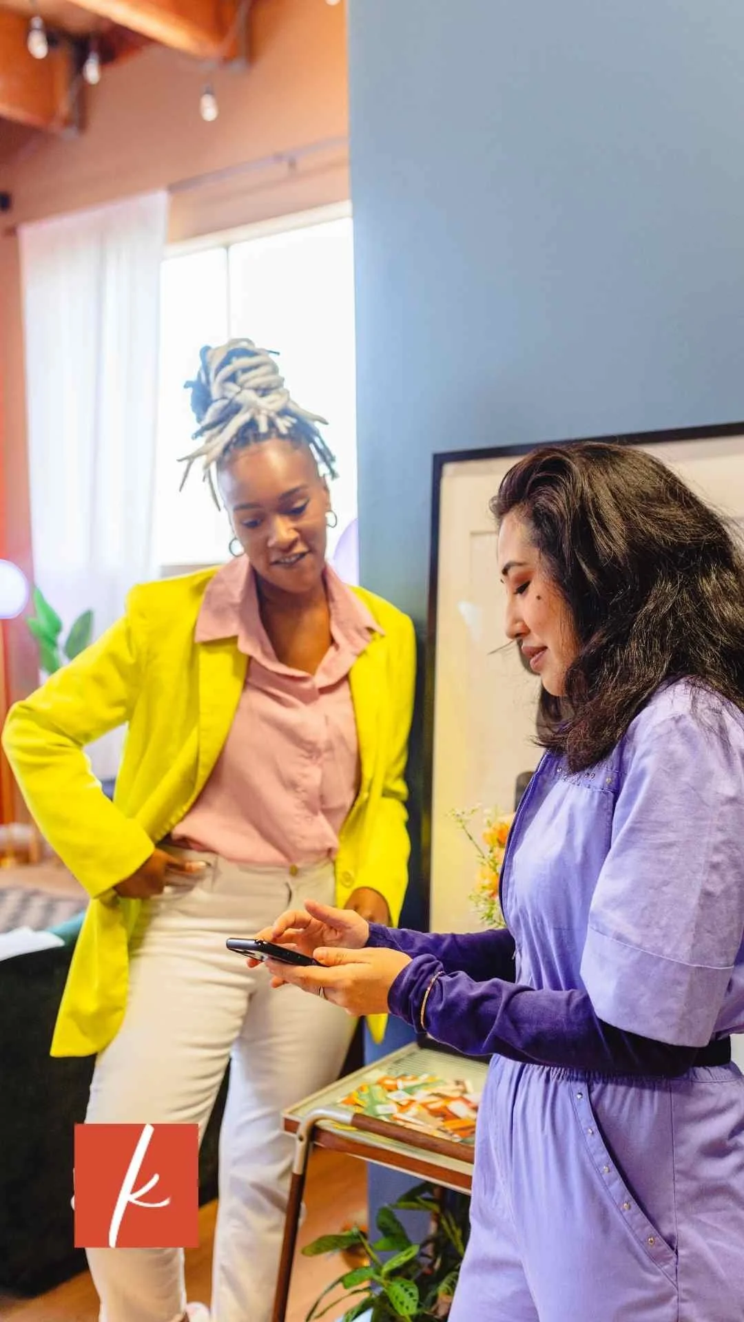 Two women talking in a casual business setting.