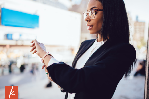 Professional looking woman looking at her watch
