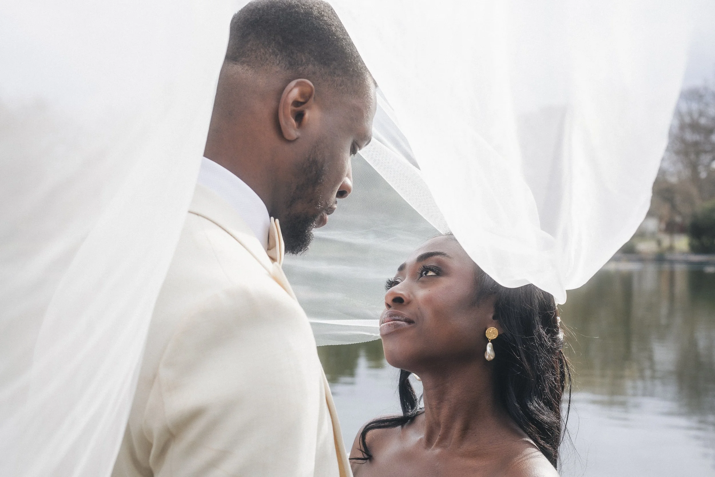 Romantic wedding couple under veil outdoor