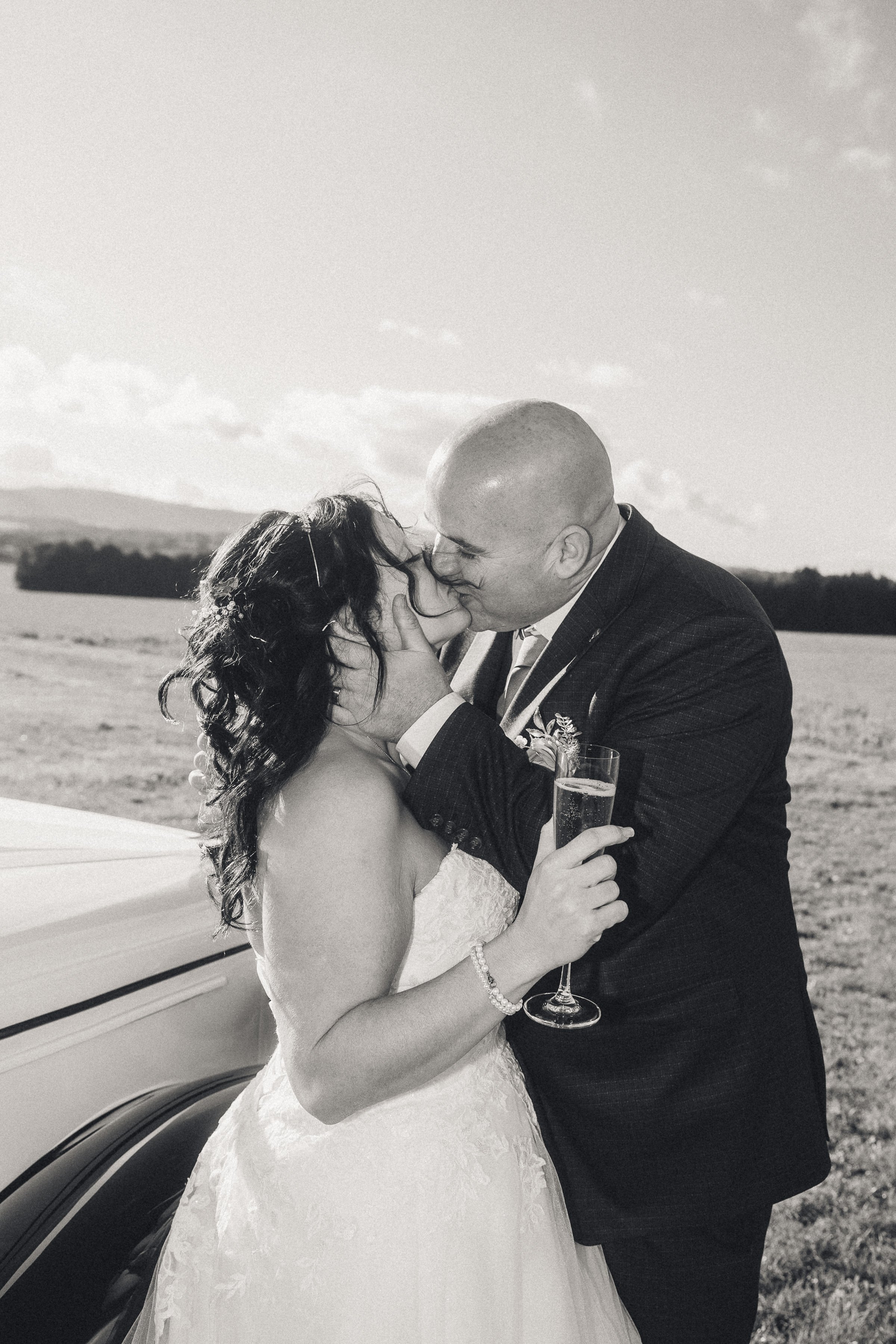 Romantic wedding couple kissing outdoor black and white