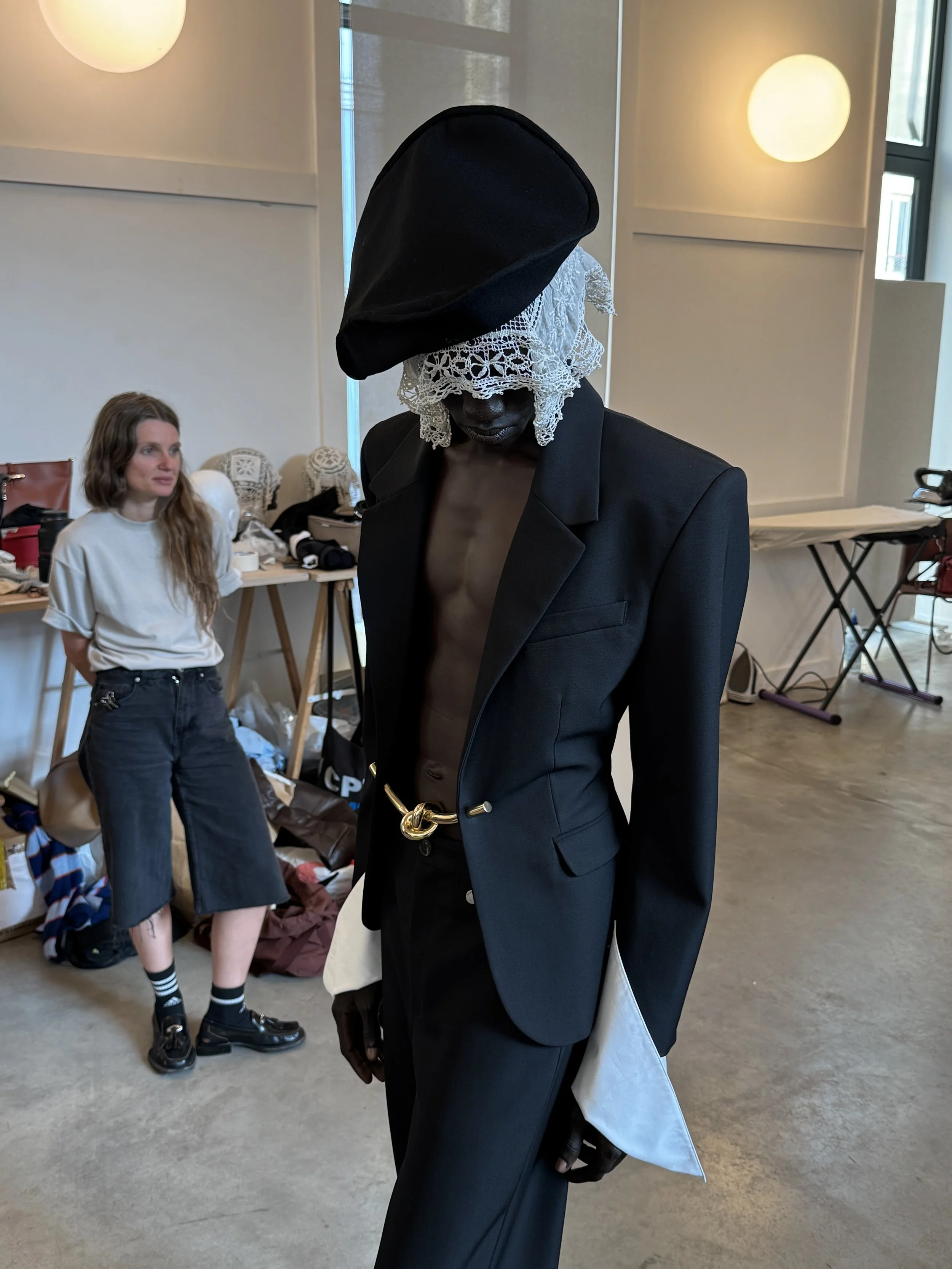 Final womenswear look prepared for runway presentation following draping and fitting adjustments