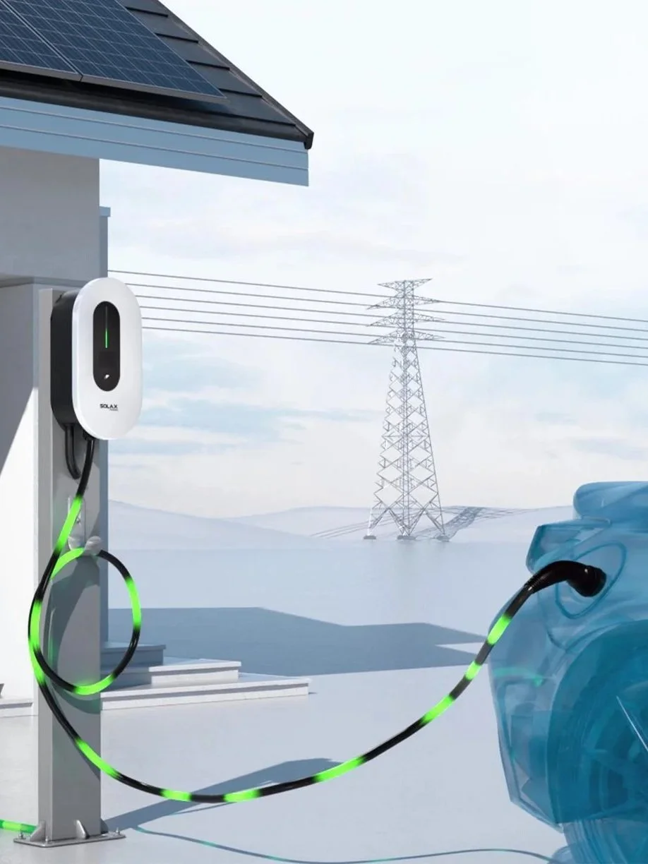 An electric vehicle connected to a charging station outside a house with solar panels on the roof and power lines in the background.