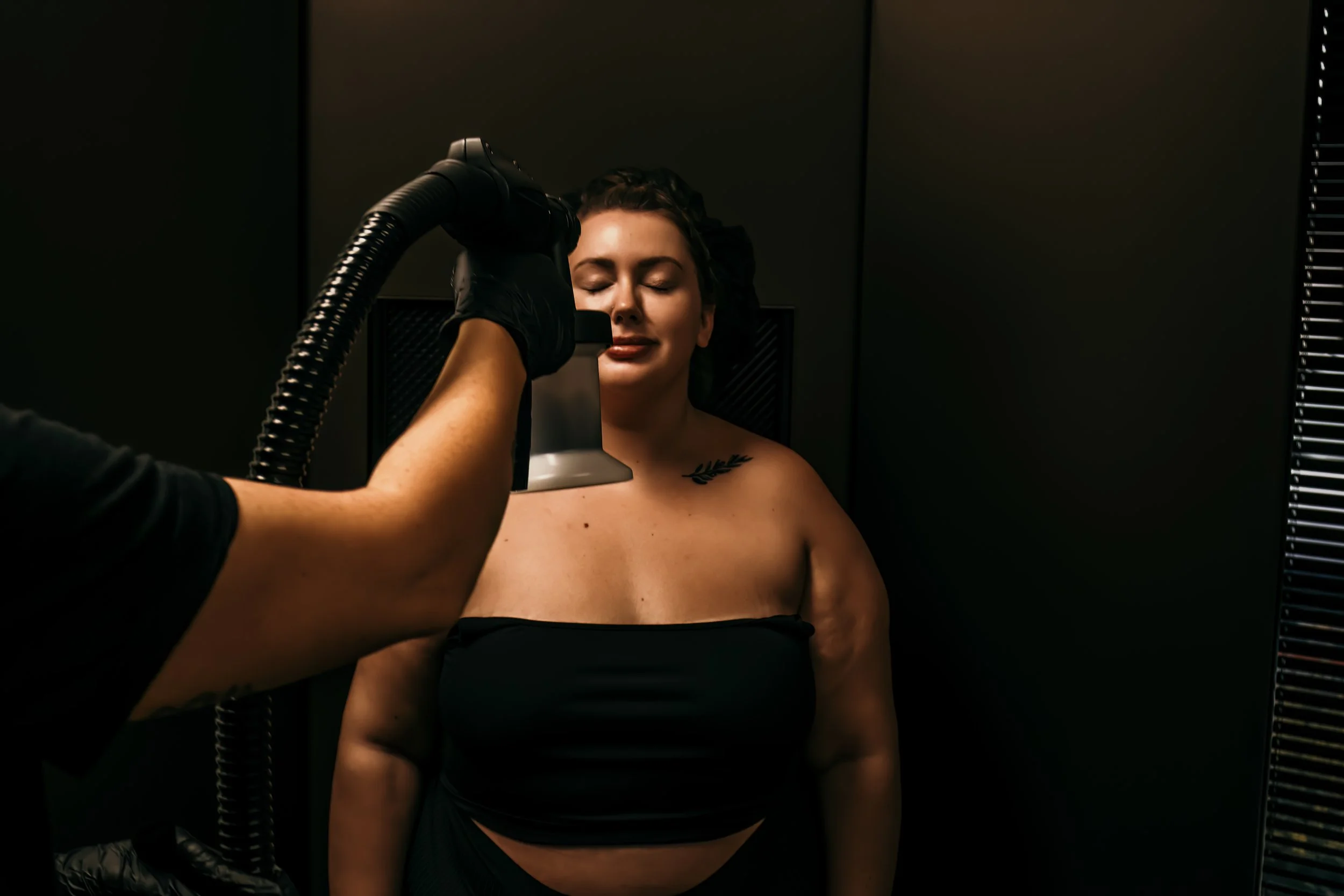 A woman receiving a spray tan