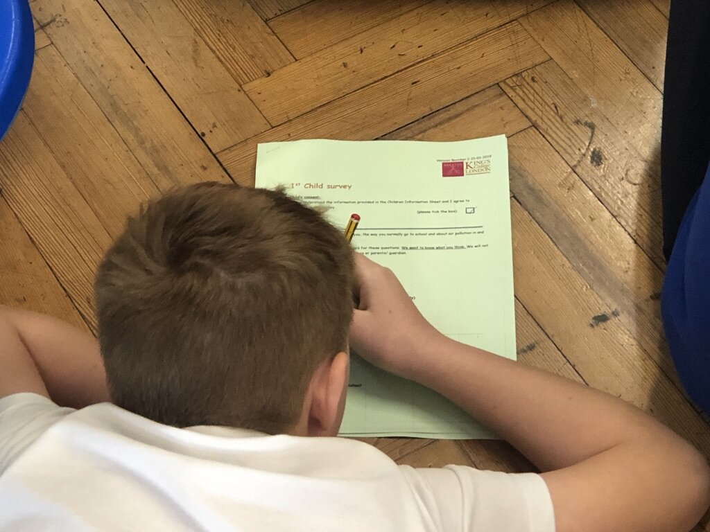 child writing in classroom