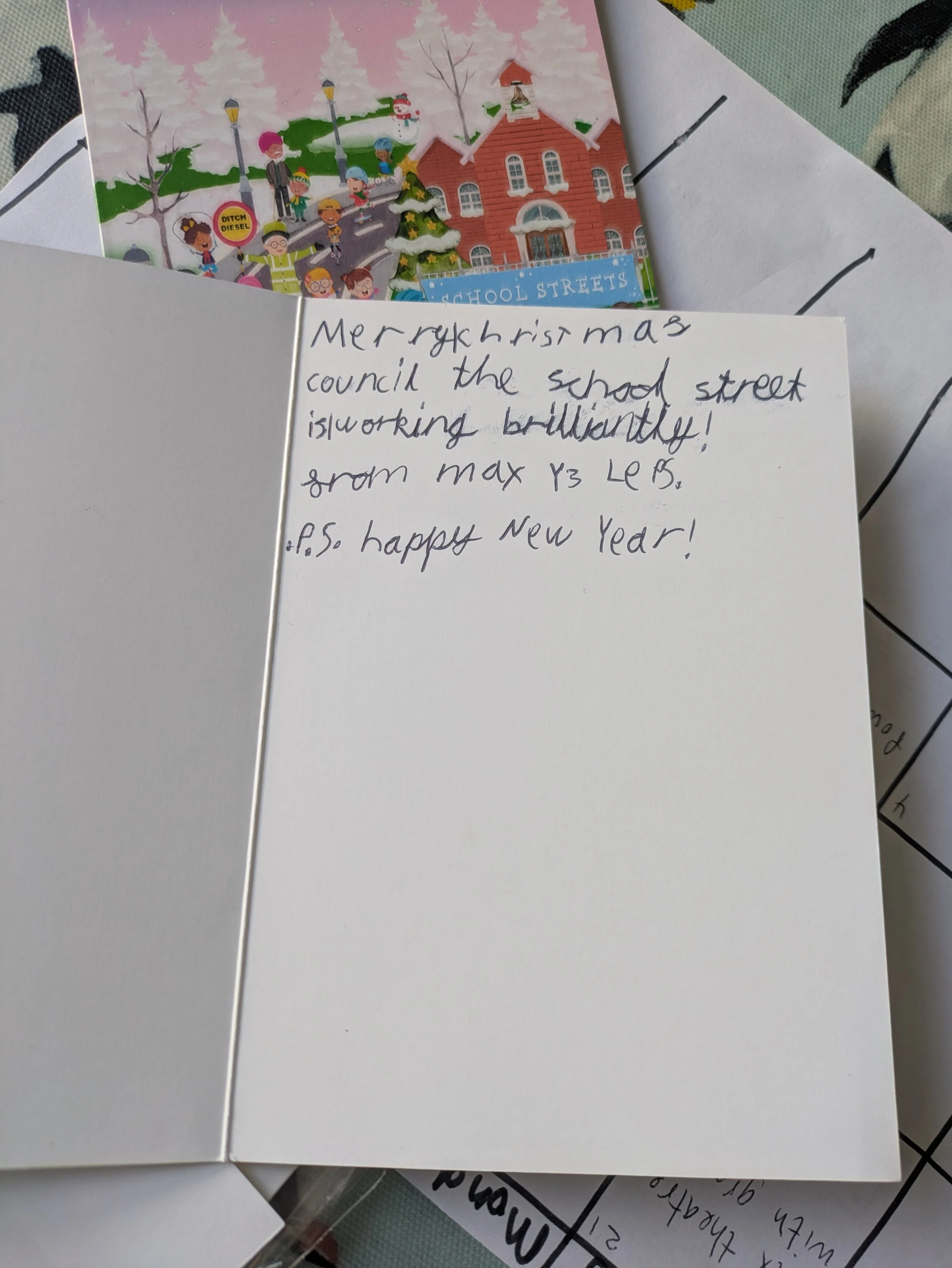 Photo of the inside of a Christmas card with text written in it: "Merry christmas council the school street is working brilliantly! From Max Y3 LEPS. P.S. happy New Year!
