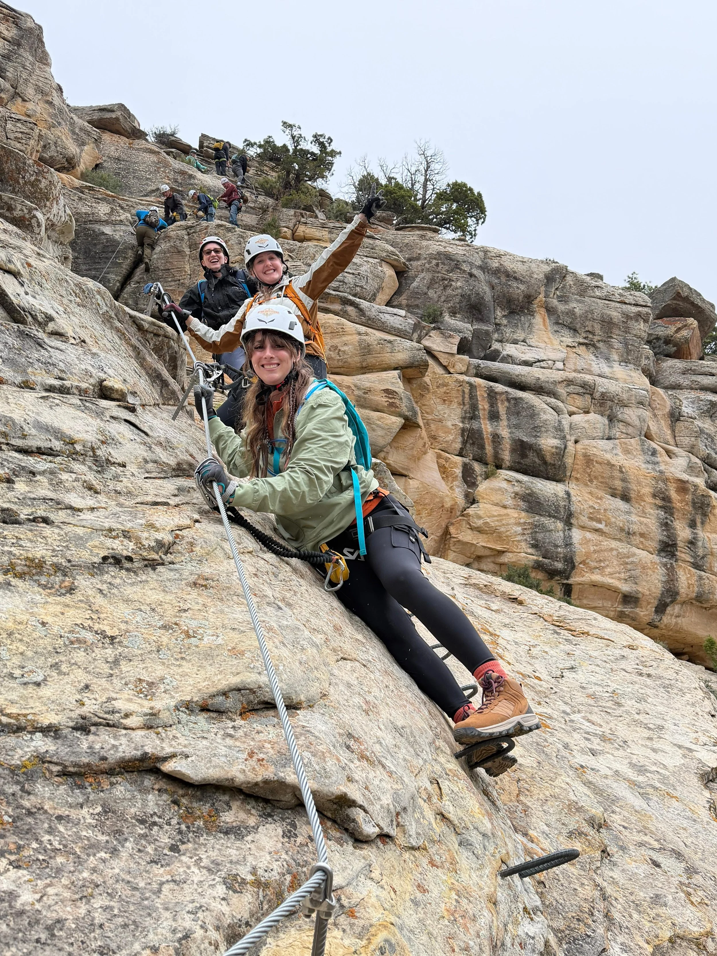 Via ferrata climber connected to the fixed cable while downclimbing Outlaw.