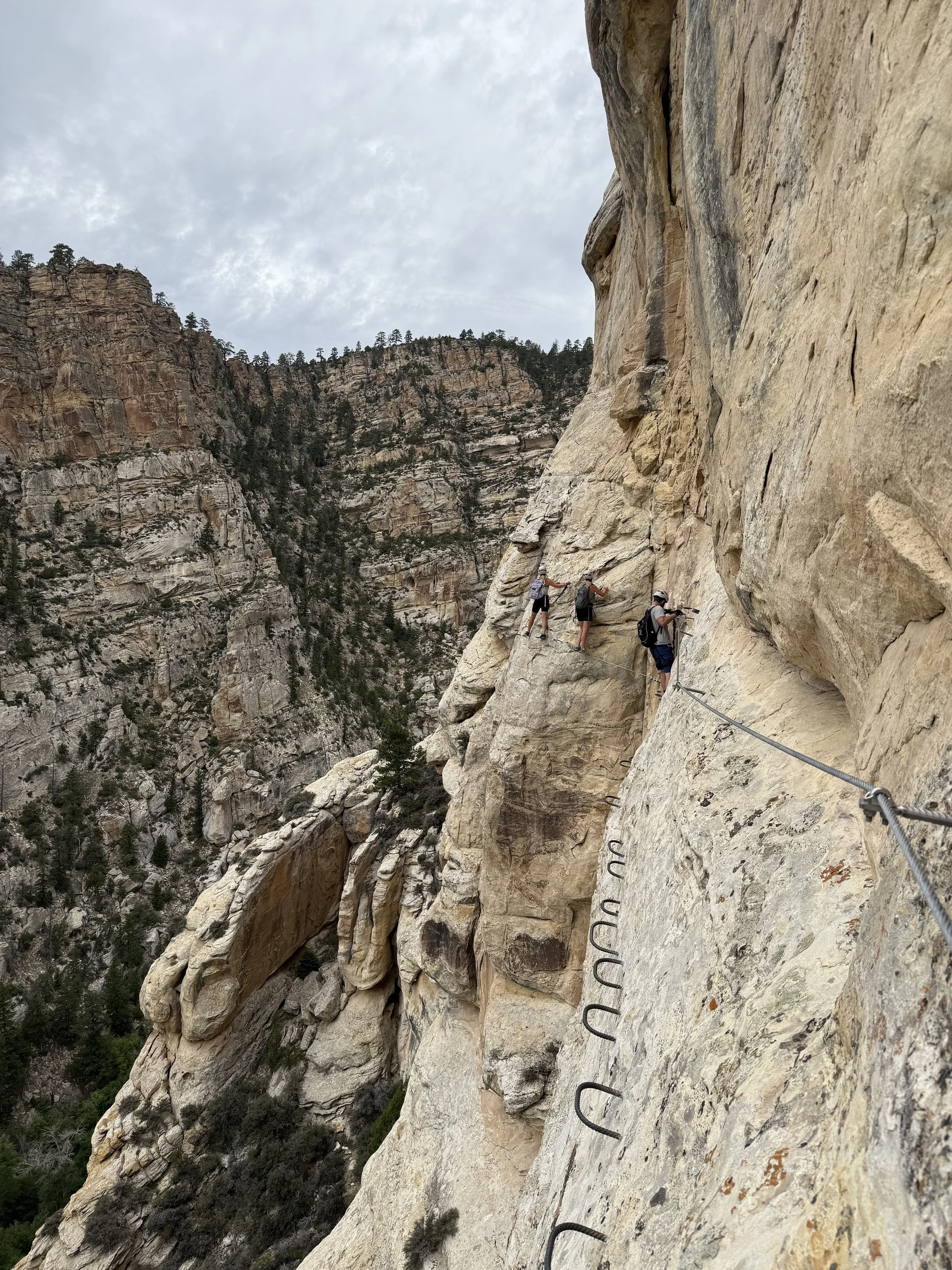 People climbing the ashley gorge via ferrata in vernal on the pump sector.