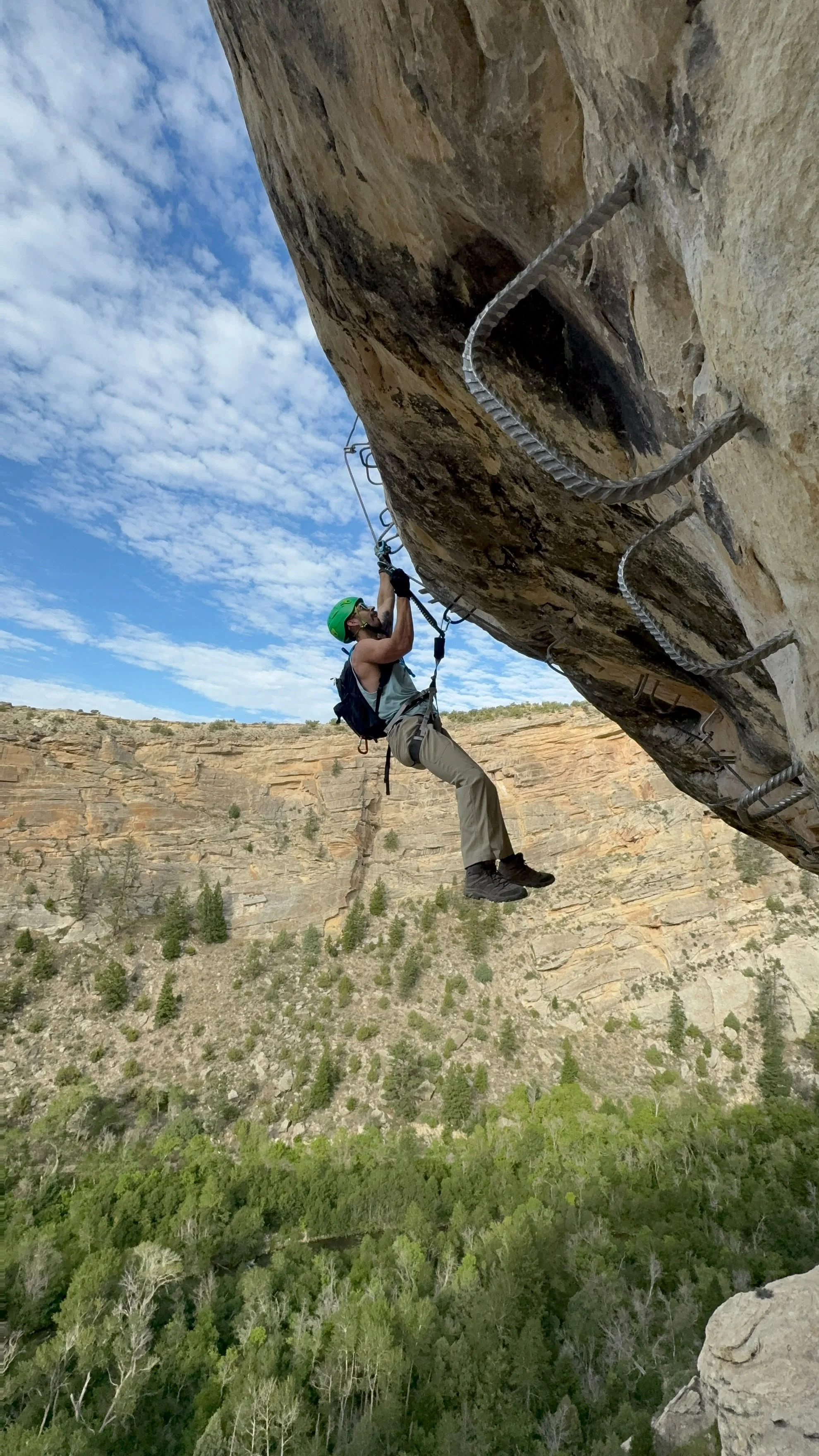 Strong climber moving across the overhanging Syntax Error roof variation.