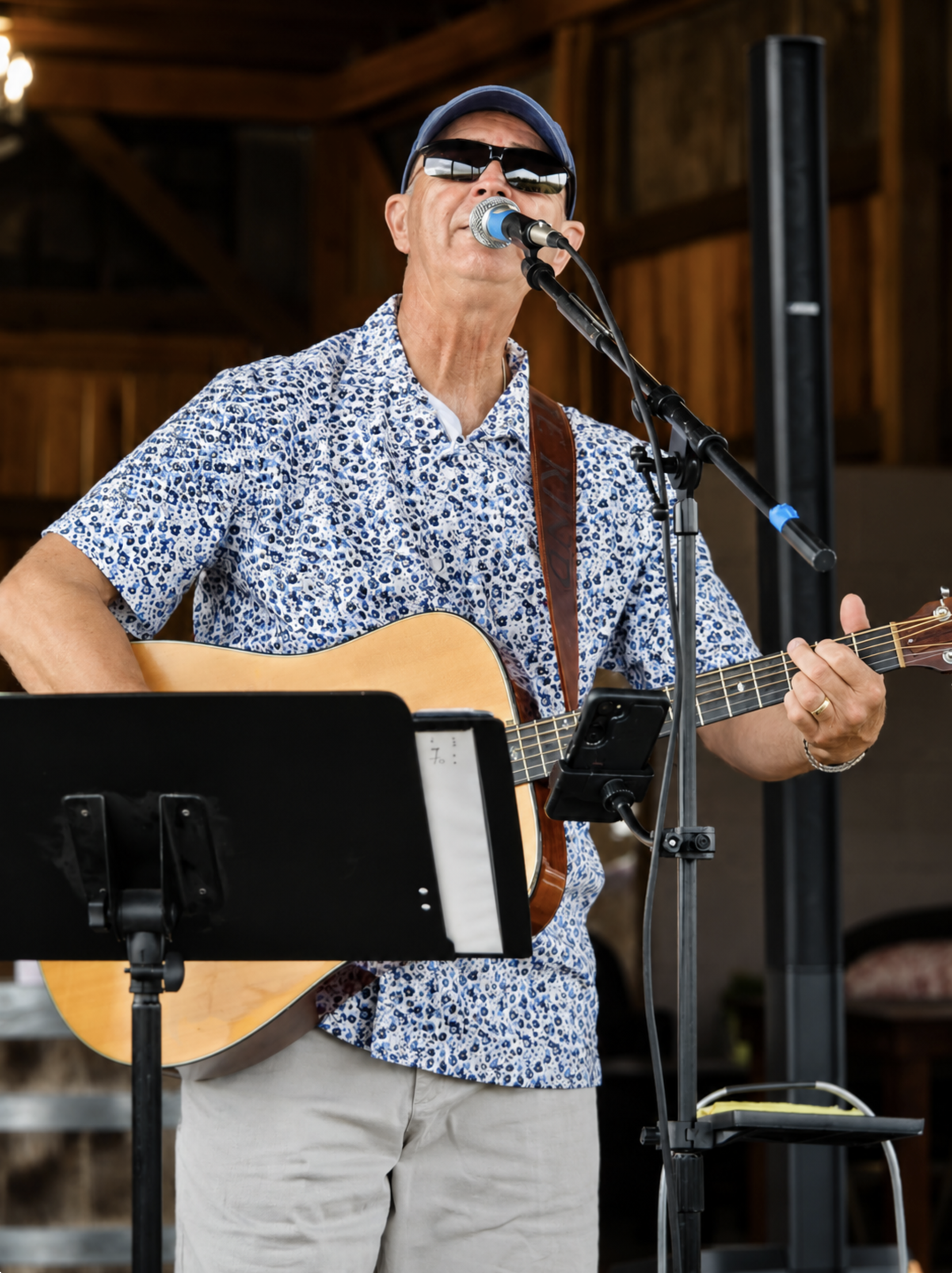 Ken Johnson sings and plays acoustic guitar during a live music performance at Addison Farms Vineyard.