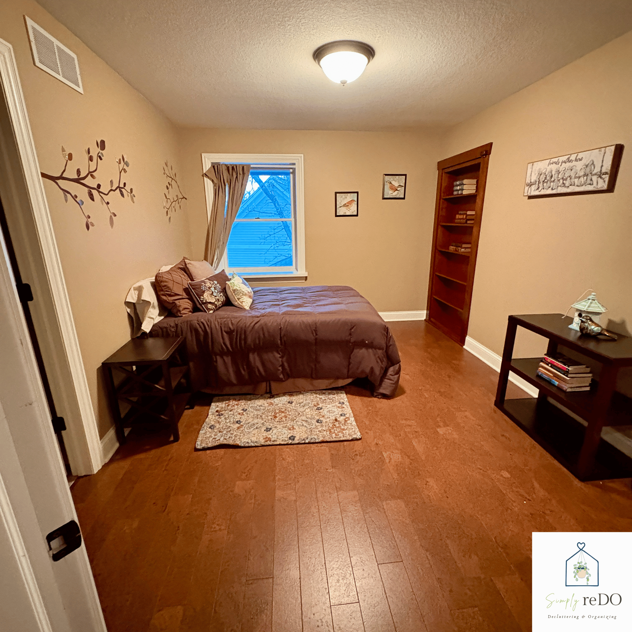 Guest bedroom after organization, straight-on view from the hallway showing a calm, functional layout.