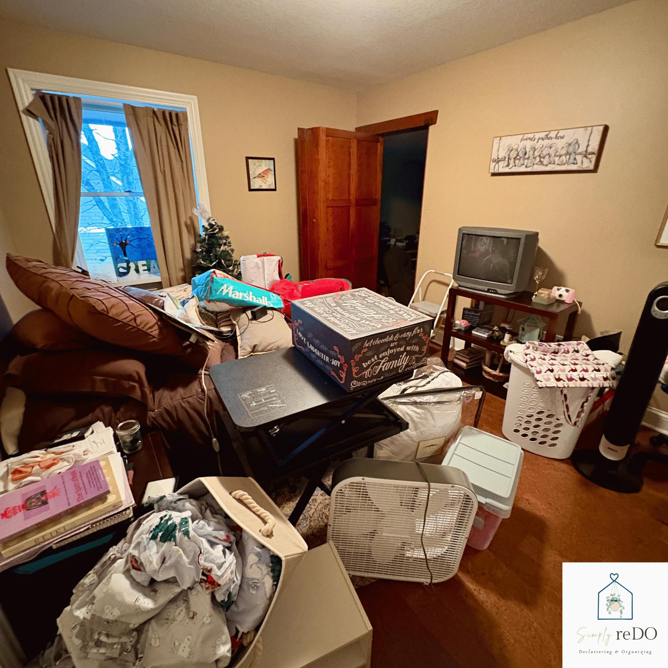 Guest bedroom before organization, angled view from the bathroom doorway.