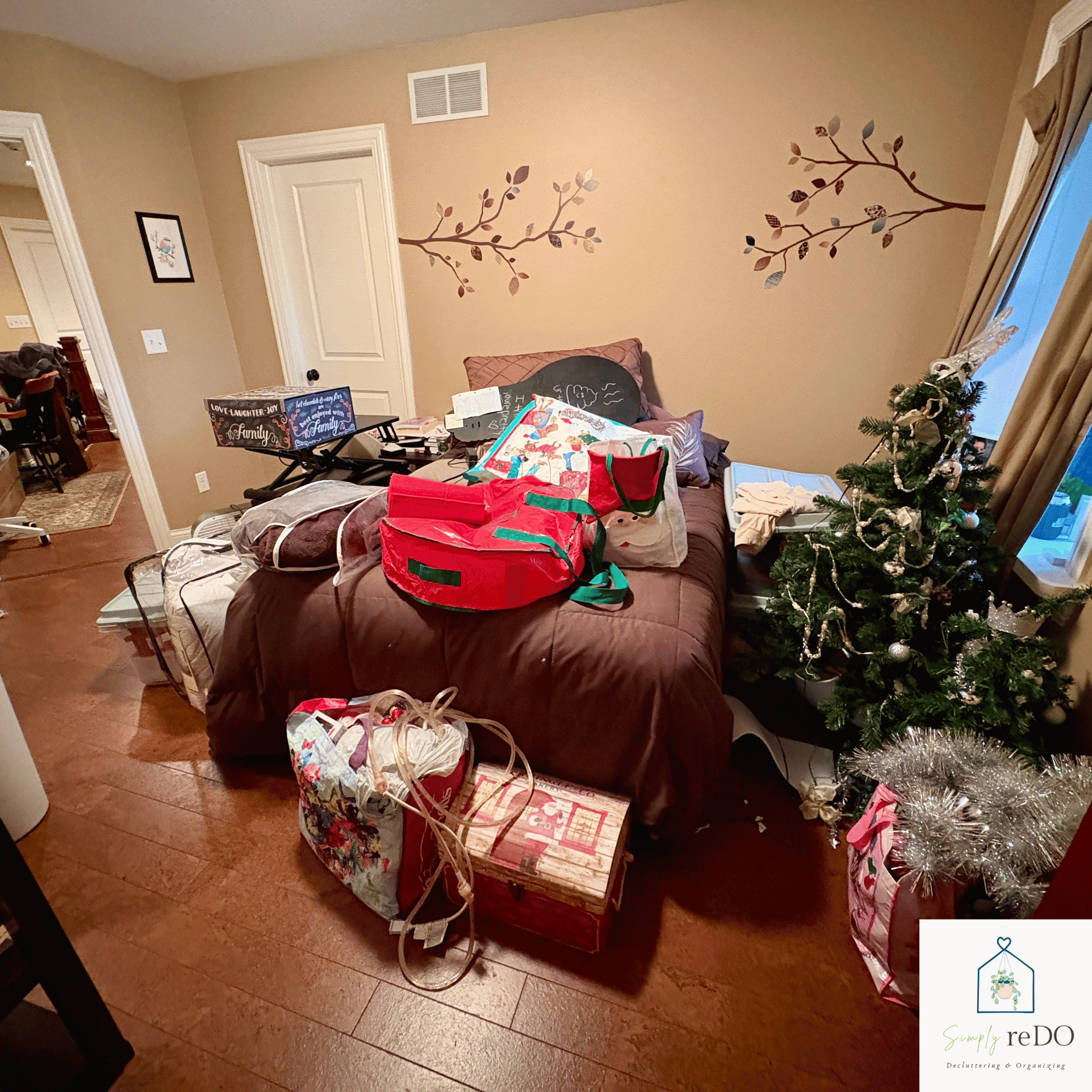 Guest bedroom before organization, view from the foot of the bed with the hidden door behind the camera.