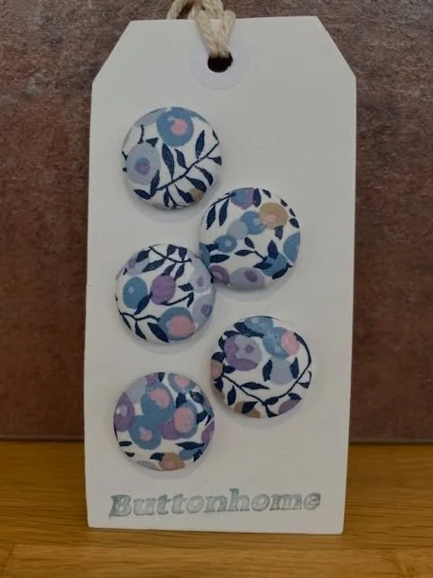 Another returning exhibitor, welcome back @buttonhome1 for 2026!

Buttonhome offers handmade fabric noticeboards, fabric buttons and fabric button items, including bookmarks and magnetic pin/needle holders, along with fabric covered embroidery hoops 