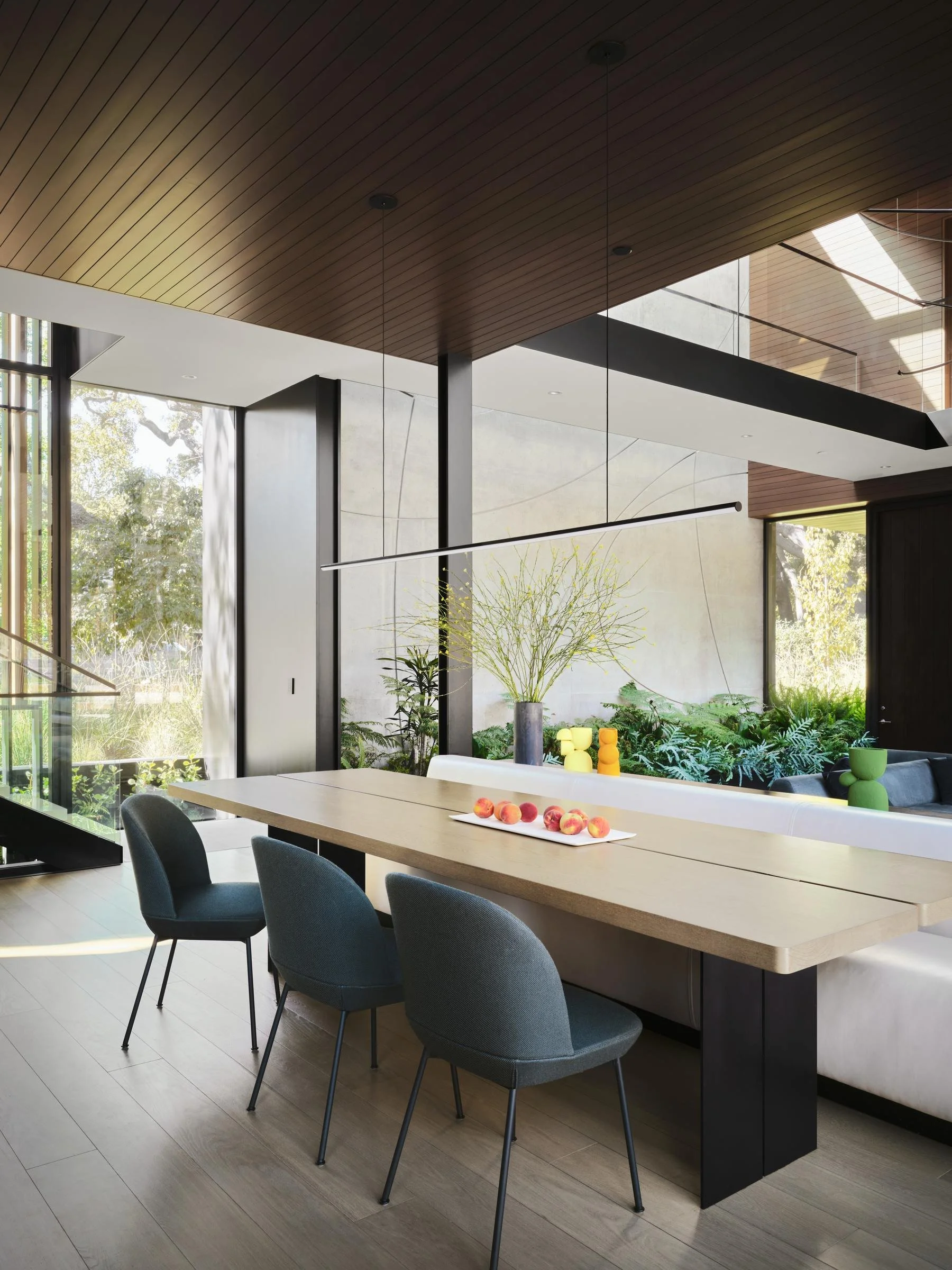 Wood-framed windows and doors frame a private courtyard at the Atherton residence.
