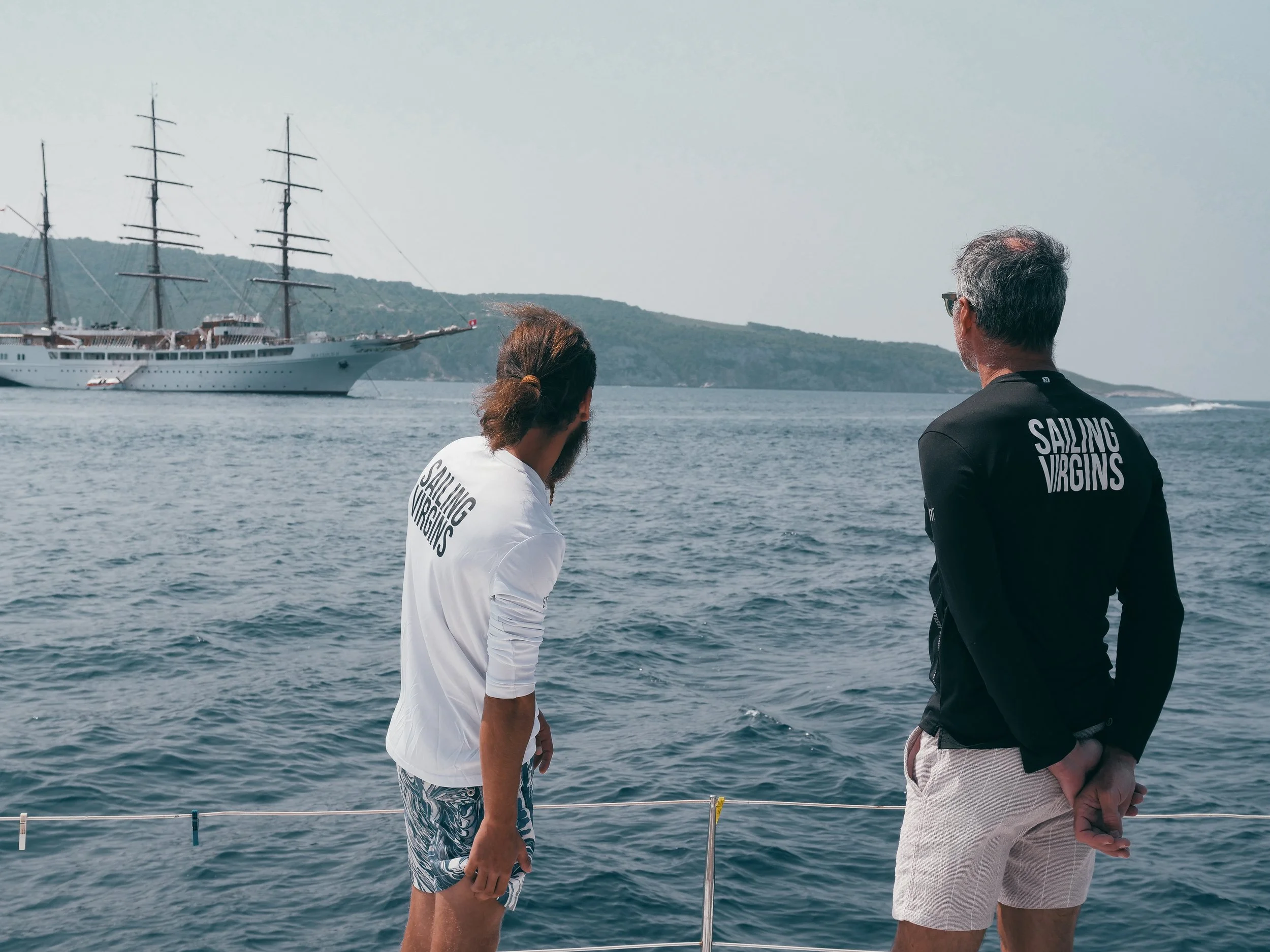 Two male sailors looking out to sea.jpg