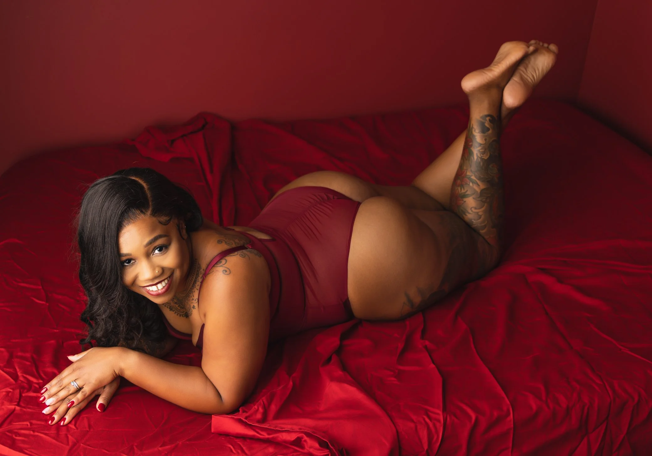 playful-boudoir-portrait-red-sheets-sensual-confidence.jpg