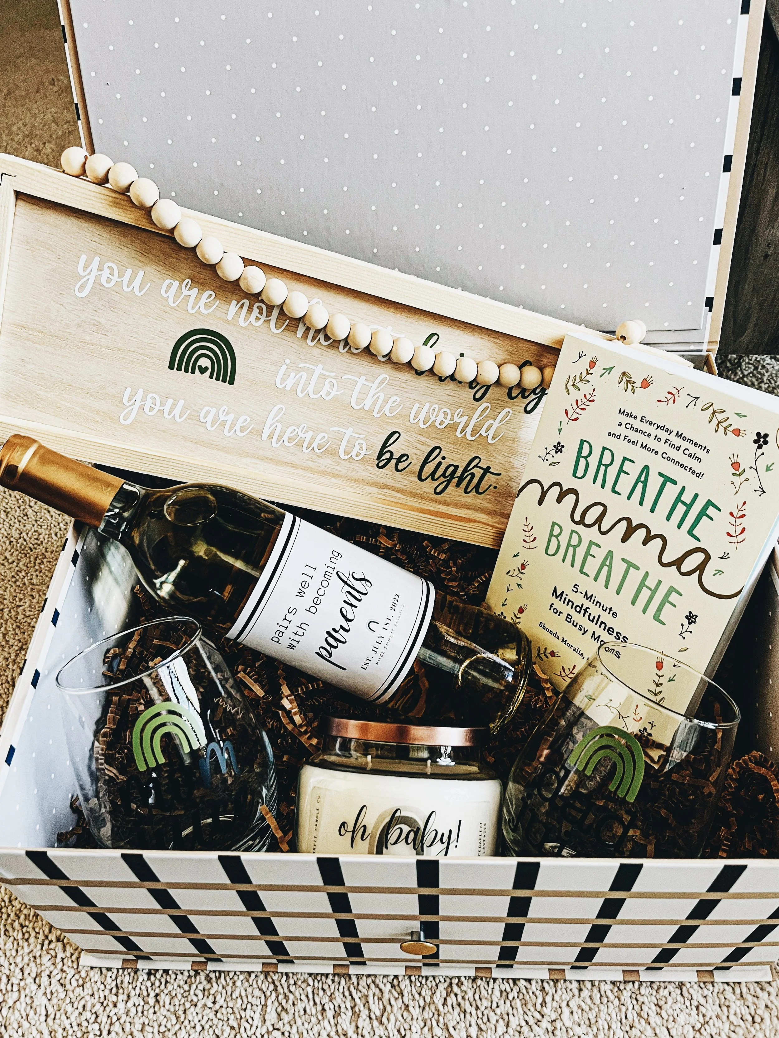custom new baby gift box with book, candle, wine glasses, a sign, and a bottle of wine