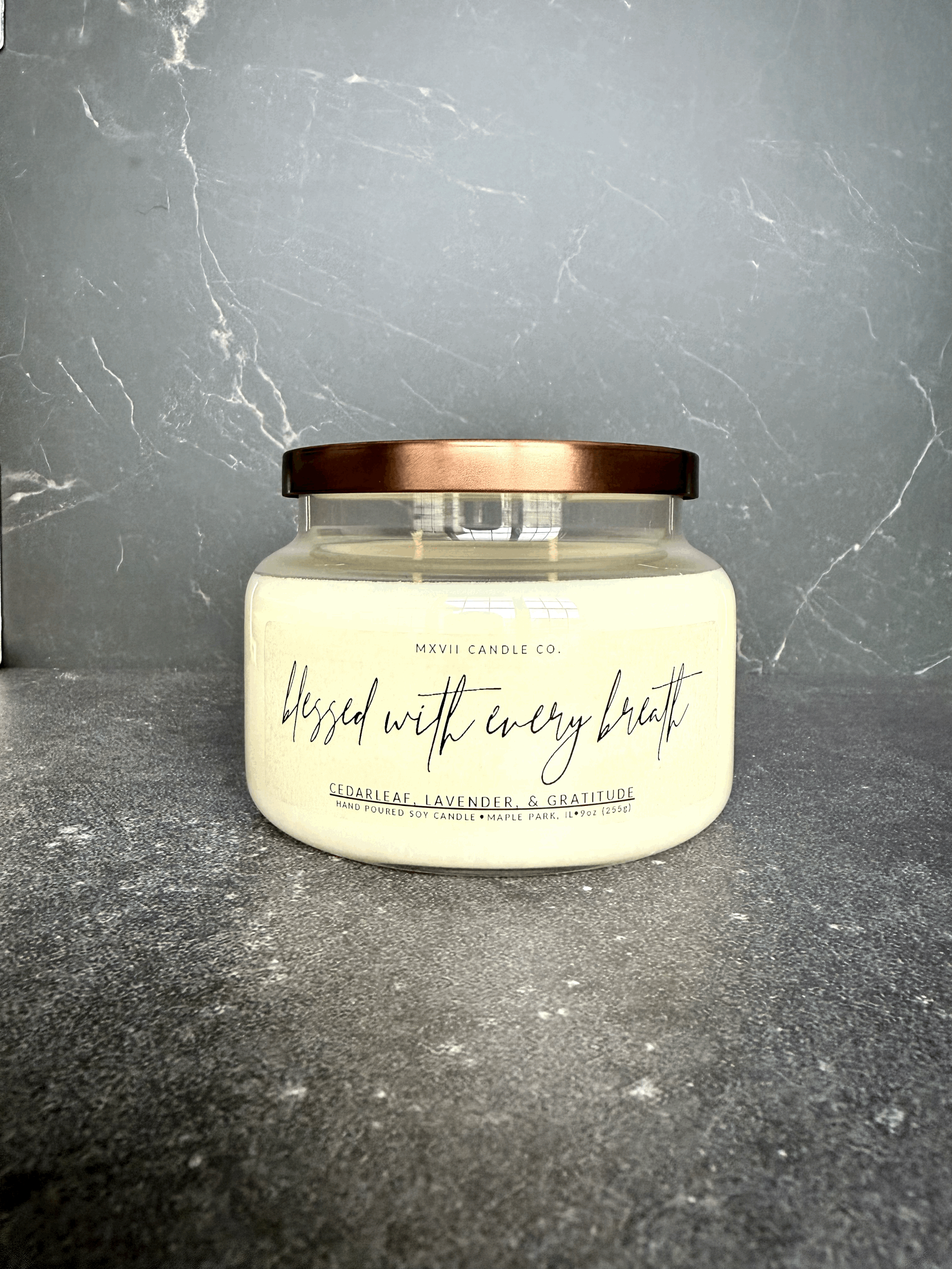 Cedarleaf Lavender soy candle in a clear jar with copper lid on black marble background — Blessed with Every Breath by MXVII Candle Co.