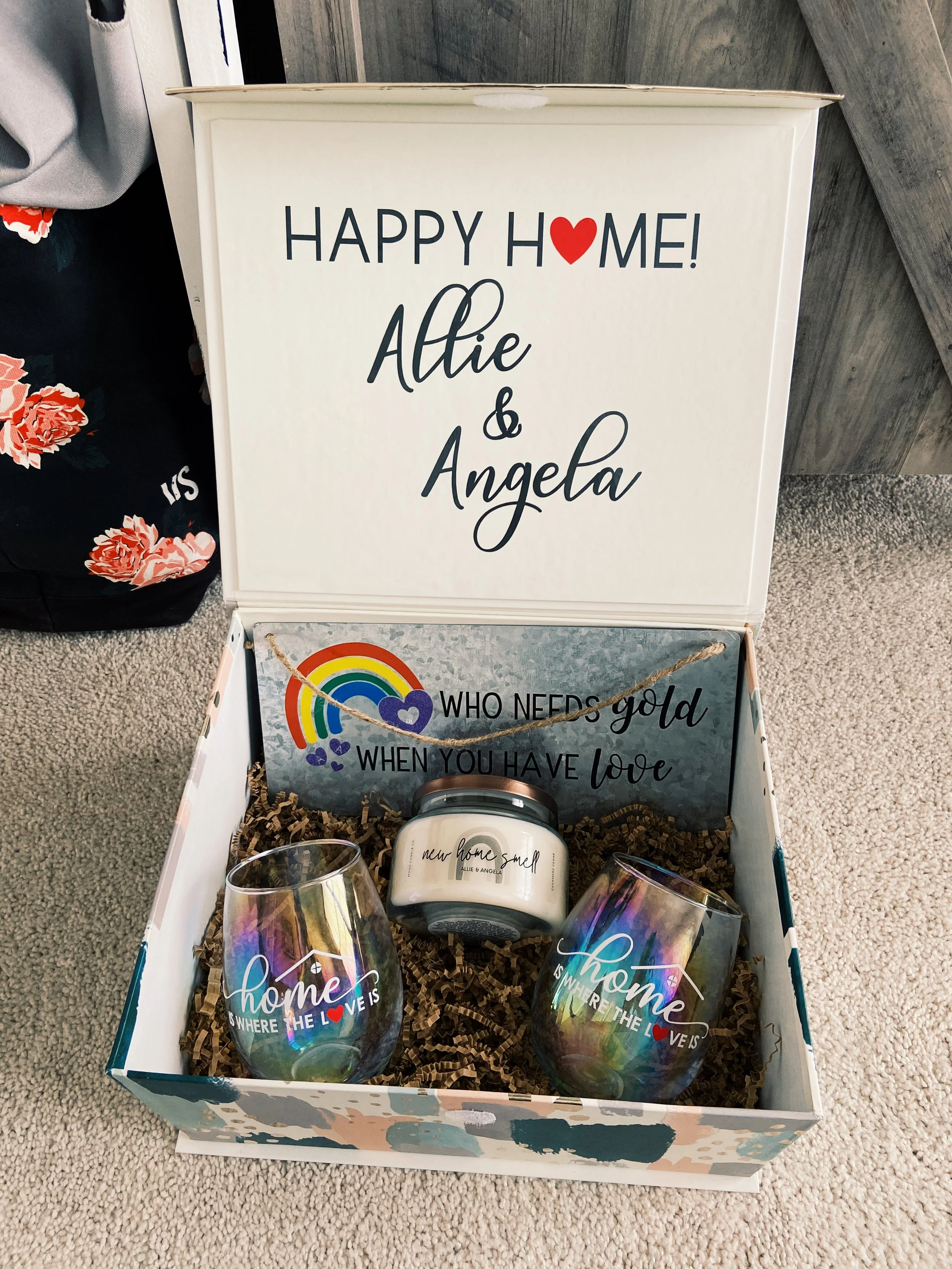custom housewarming gift box with wine glasses and a candle and personalized sign